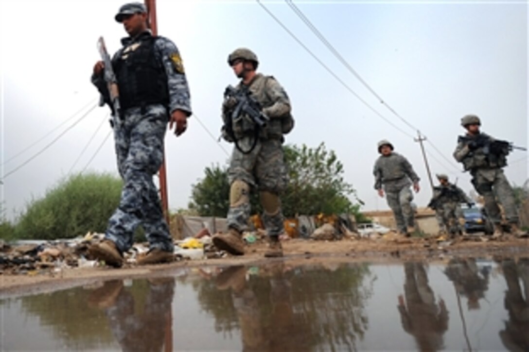 U.S.  Army soldiers patrol with Iraqi soldiers in the Doura community of southern Baghdad, Iraq, Oct. 29, 2008. The soldiers are assigned to the 2nd Battalion, 4th Infantry Regiment, 1st Brigade Combat Team, 4th Infantry Division.