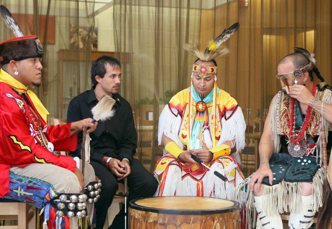 Josh Gibbs, Jonathan Ward, John Oxendine and Terry White prepare for a group drum session on a traditional Native American drum.