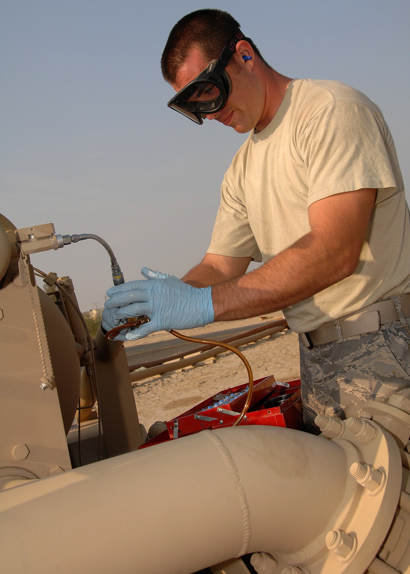 SOUTHWEST ASIA -- Staff Sgt. Michelangelo Serio, 386th Expeditionary Logistics Readiness Squadron Fuels Management Flight, takes a fuel sample from a FORCE Fuel machine on Nov. 4 at an air base in Southwest Asia. Sergeant Serio is deployed from Aviano Air Base, Italy. (U.S. Air Force photo/Tech. Sgt. Raheem Moore)