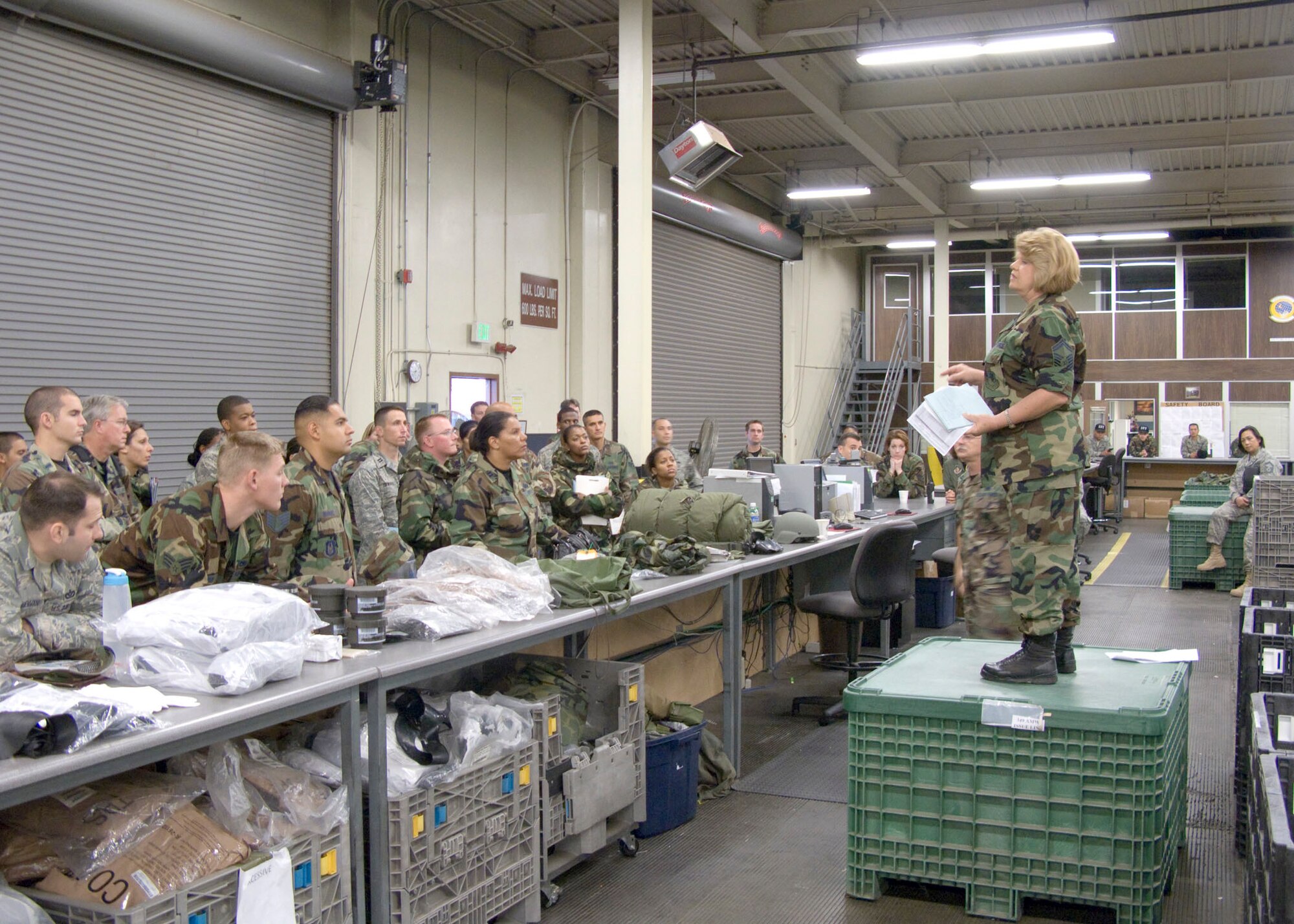 TRAVIS AIR FORCE BASE, Calif. -- Senior Master Sgt. Alice Webster, 349th Logistics Readiness Squadron, tells Airmen how mobility equipment will be issued during a deployment processing exercise Nov. 1, 2008. The deployment process ensures Airmen are properly equipped, fully qualified and quickly transported to their wartime or contingency mission. This exercise is just one of several preparing the 349th Air Mobility Wing for a major operational inspection next year. (U.S. Air Force photo / Maj. Robert Couse-Baker)