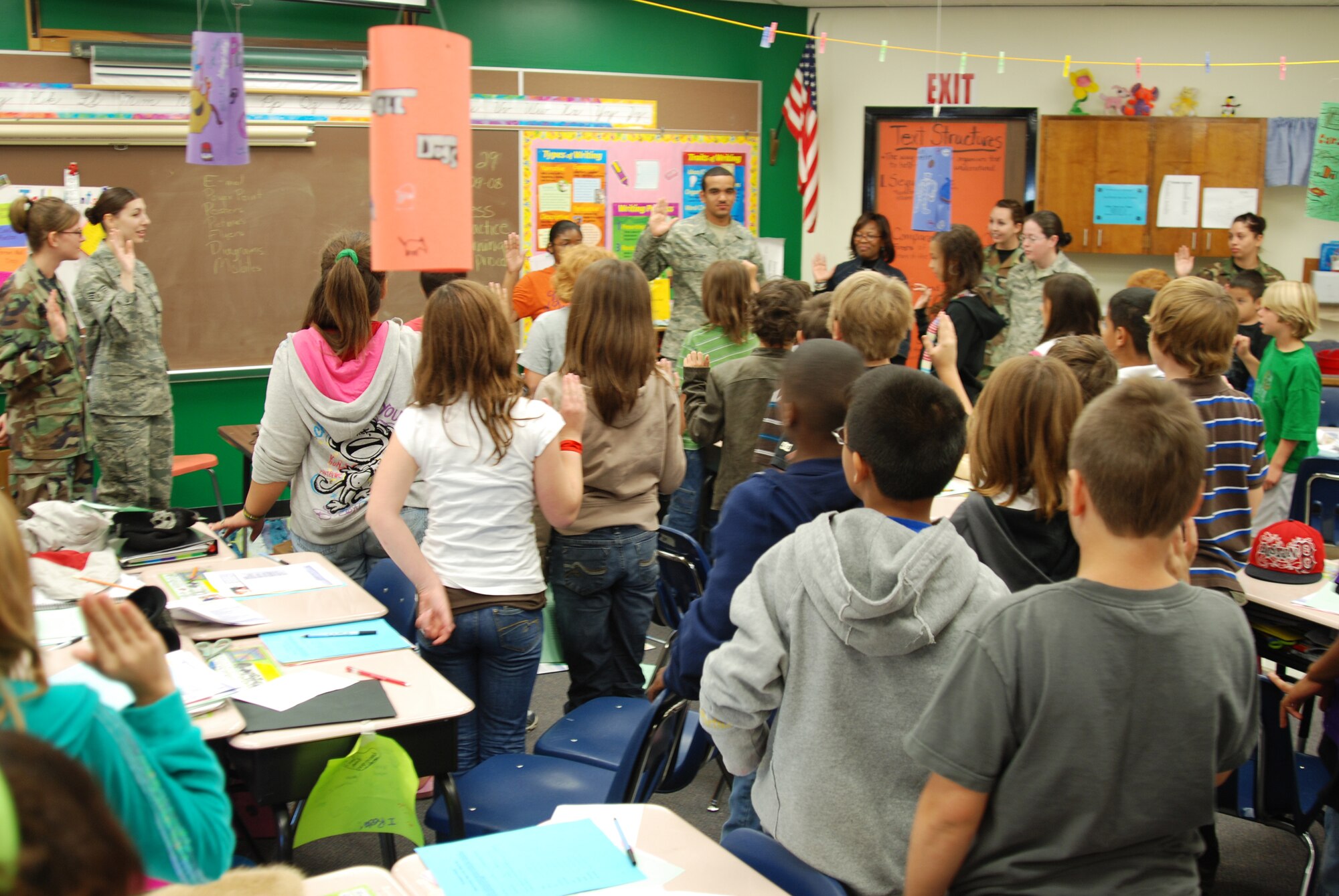 MCCONNELL AIR FORCE BASE, Kan. -- Fifth grade students from College Hill Elementary School, Wichita, Kan., raise their hands while taking an oath to say no to underage drinking, Oct. 29, during a Red Ribbon Week presentation led by McConnell Airmen.  (Photo by Airman 1st Class Jessica Lockoski)