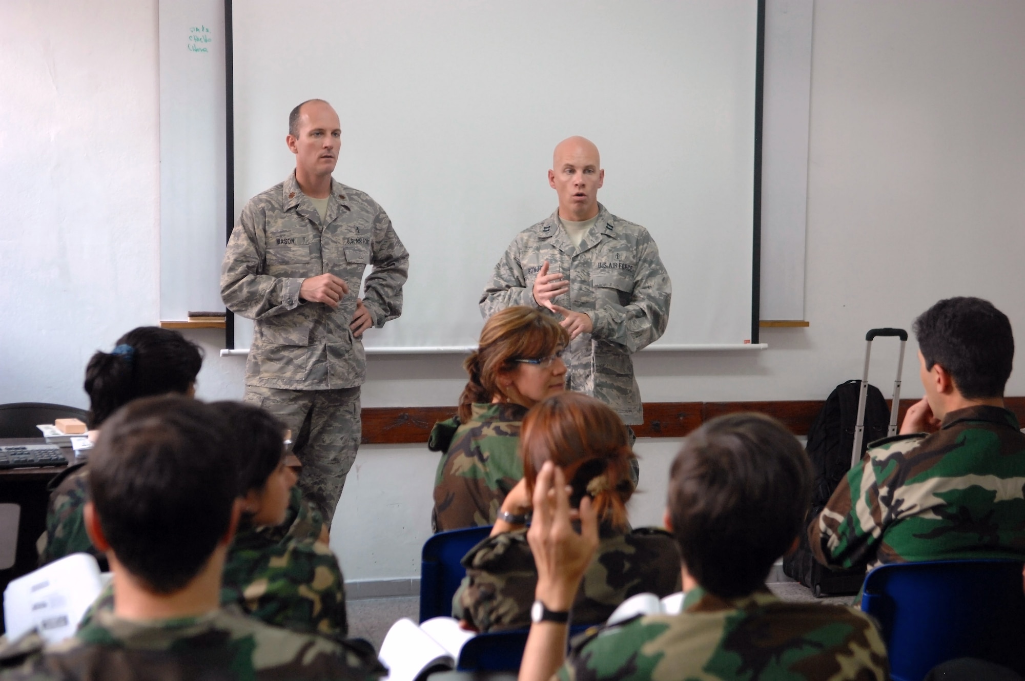 Maj. Phillip Mason (left) and Capt. Timothy Bonjour answer questions from Uruguayan military medical counterparts on Nov. 3 in Uruguay. They are part of a Defense Institute for Medical Operation disaster response and medical technique exchange. Major Mason is from Wright-Patterson Air Force Base, Ohio, and Captain Bonjour is from Travis AFB, Calif. (U.S. Air Force photo/Tech. Sgt. Roy Santana)