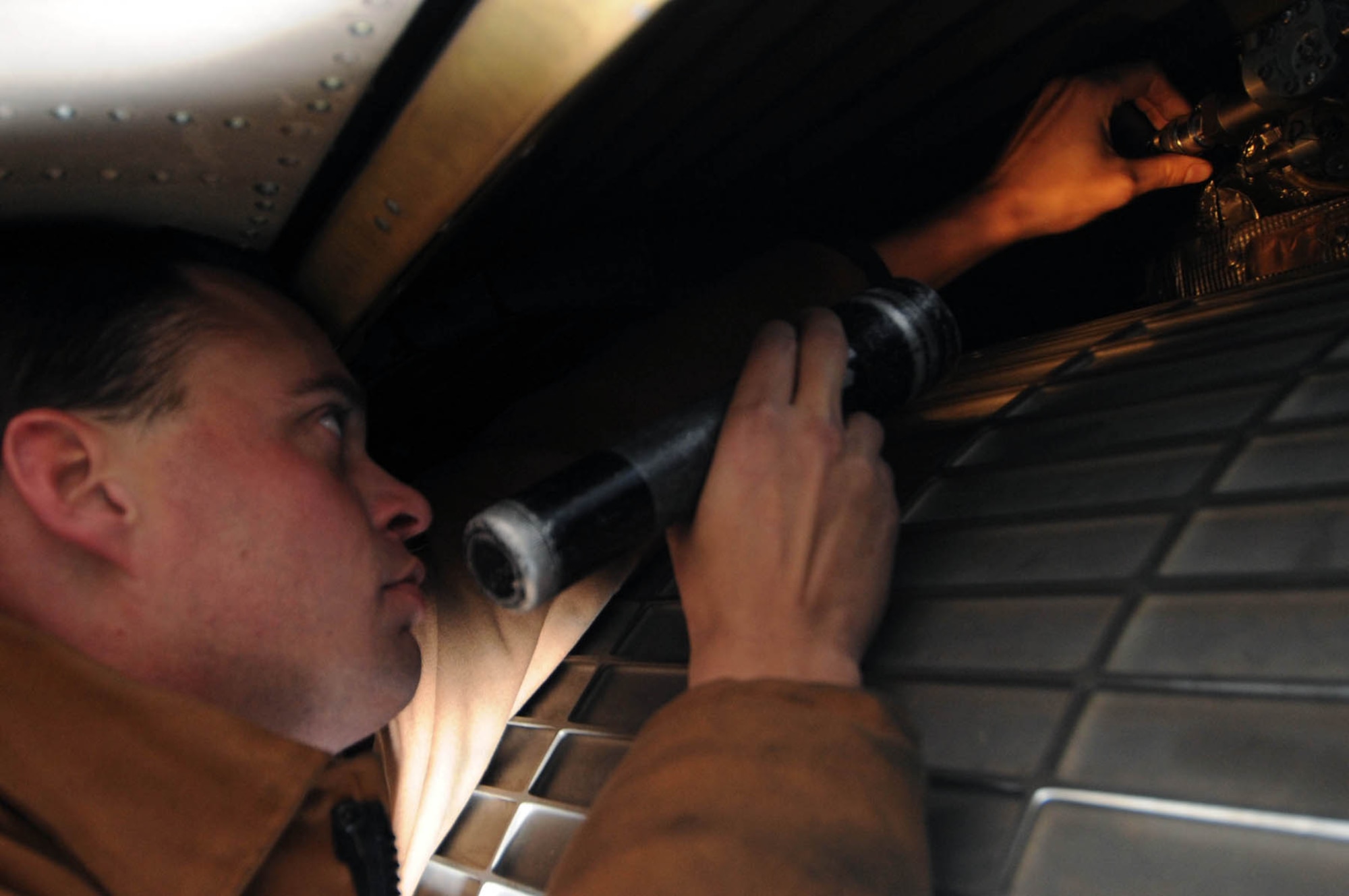 Staff Sgt. Timothy Merrill, 28th Aircraft Maintenance Squadron electrician, inspects the condition of a cannon plug on a B-1B Lancer jet engine here, Nov. 5. The cannon plug delivers electrical signals controlling the engine crew compartment. (U.S. Air Force photo by Airman Corey Hook)