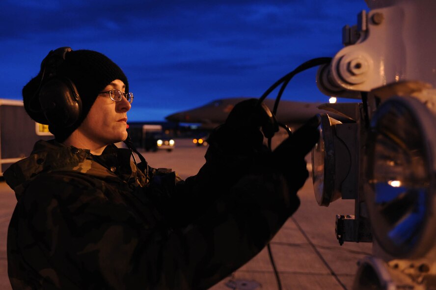 Airman 1st Class Anne-Marie Vasquez, 28th Aircraft Maintenance Squadron load crew member journeyman, plugs an intercom ground cord into B-1B Lancer here, Nov. 5. This cord enables communication with maintainers in the cockpit and also during launch and recovery procedures. (U.S. Air Force photo by Airman Corey Hook)