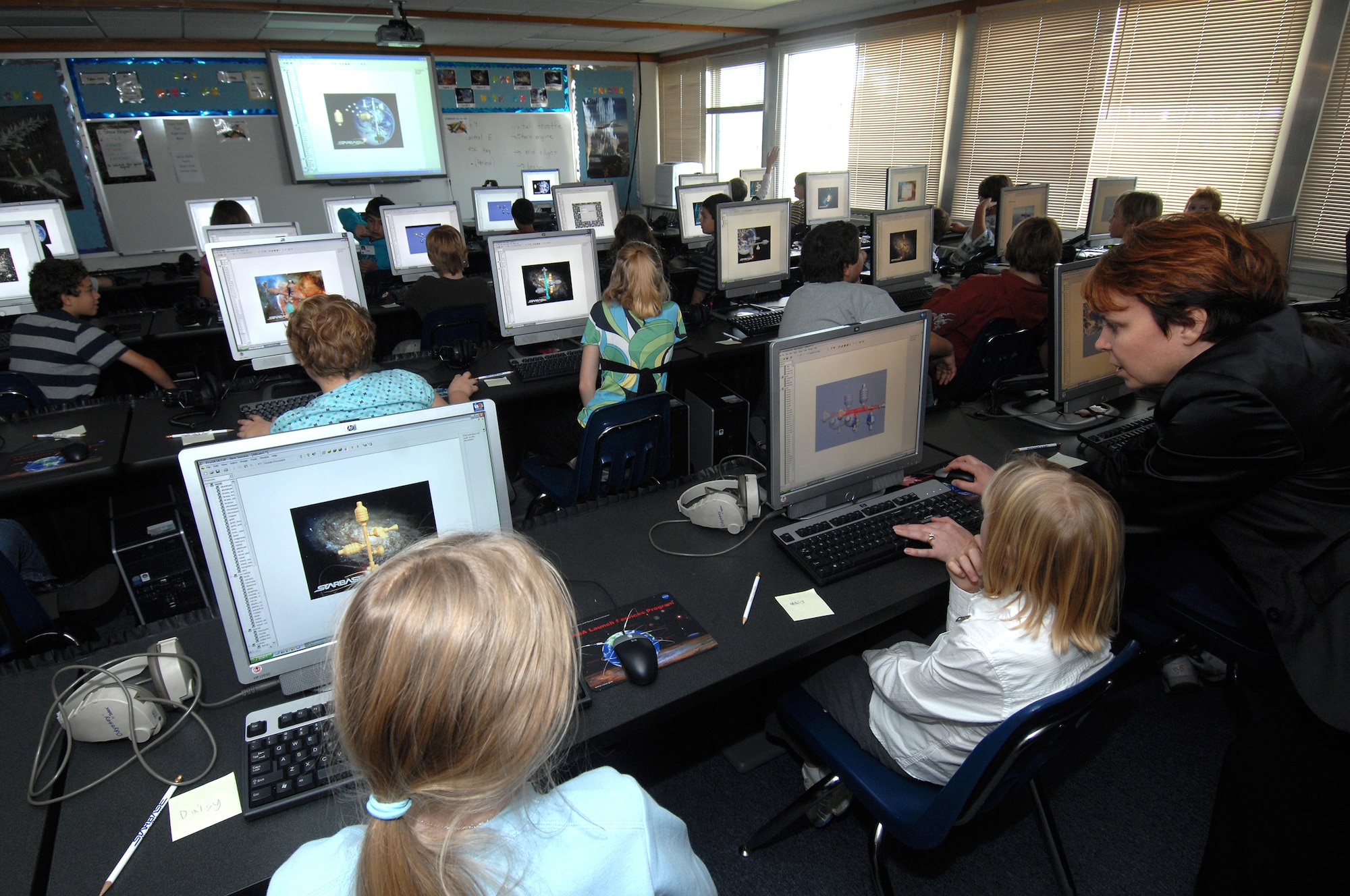 MINOT AIR FORCE BASE, N.D. – Terri Vigstol, STARBASE North Dakota instructor, aids students in creating a 3-D space station model during the Department of Defense-funded education program STARBASE here  Nov. 3. The DoD STARBASE program the program brings fifth-graders here once a month for five days of science, technology, engineering and math – including launching rockets, and motivates children to harness the power of the mind through hands-on, minds-on learning and development. (U.S. Air Force photo by Senior Airman Kelly Timney)