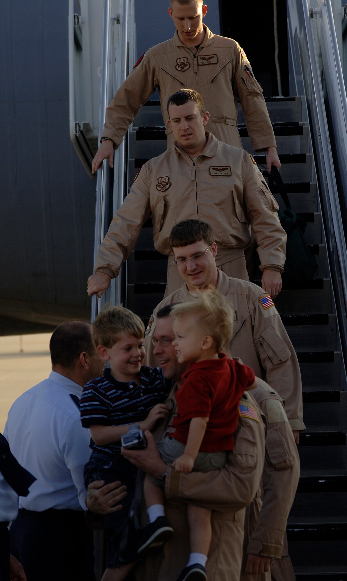 MCCONNELL AIR FORCE BASE, Kan. -- Lt. Col. Samuel Chesunt, 344th Air Refueling Squadron holds his two sons, Carson, 5, and Evan, 2, after returning from deployment, Nov. 3.  Many Team McConnell members returned home after spending months away from family members and friends in locations around the world.  (Photo by Staff Sgt. Ronald Lafosse)