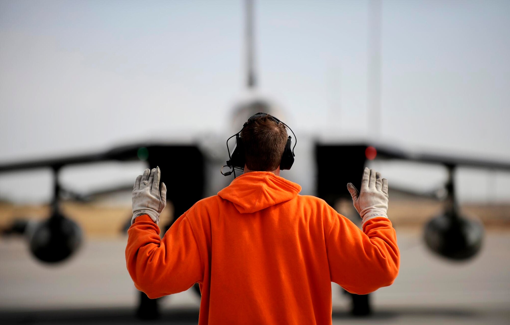 MOUNTAIN HOME AIR FORCE BASE, Idaho -- A German air force crew chief directs a Tornado indicator/ strike aircraft into position on the flightline here Oct. 14. During a two week training mission the GAF was flying with Mountain Home AFB F-15E Strike Eagles in simulated combat missions. (U.S. Air Force photo/ Airman 1st Class Ryan Crane)