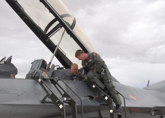Col. Jerry Gandy (left), 95th Air Base Wing commander, and Col. William Thornton (right), 412th Test Wing commander, prepare an F-16 Fighting Falcon for the flight as part of the runway completion ceremony Oct. 31. (Air Force photo by Airman 1st Class William O'Brien)