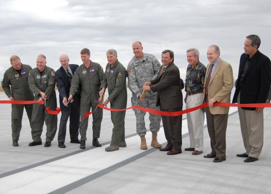 Base leadership and the runway construction team, celebrate the opening of Edwards new main runway. Edwards had to refurbish the old runway because the concrete was breaking down due to an alkali-silica reaction. The alkali and silicate in the concrete caused chemical reactions that weakened the concrete.  (Air Force photo by Airman 1st Class William O'Brien)