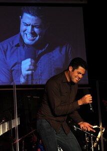 Senior Airman A. David Verde performs Queen?s ?Bohemian Rhapsody? during the Air Mobility Command Icon contest at Scott AFB, Ill., Oct. 23.  AMC Icon, loosely based around the hit TV show "American Idol," featured vocalists from all 11 AMC bases. Airman Verde is with the 437th Aerial Port Squadron. (U.S. Air Force photo/Senior Airman Jonathan Lovelady)