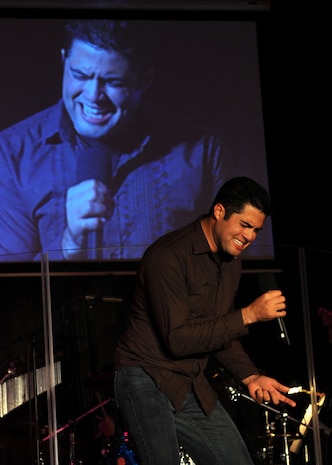 Senior Airman A. David Verde performs Queen?s ?Bohemian Rhapsody? during the Air Mobility Command Icon contest at Scott AFB, Ill., Oct. 23.  AMC Icon, loosely based around the hit TV show "American Idol," featured vocalists from all 11 AMC bases. Airman Verde is with the 437th Aerial Port Squadron. (U.S. Air Force photo/Senior Airman Jonathan Lovelady)