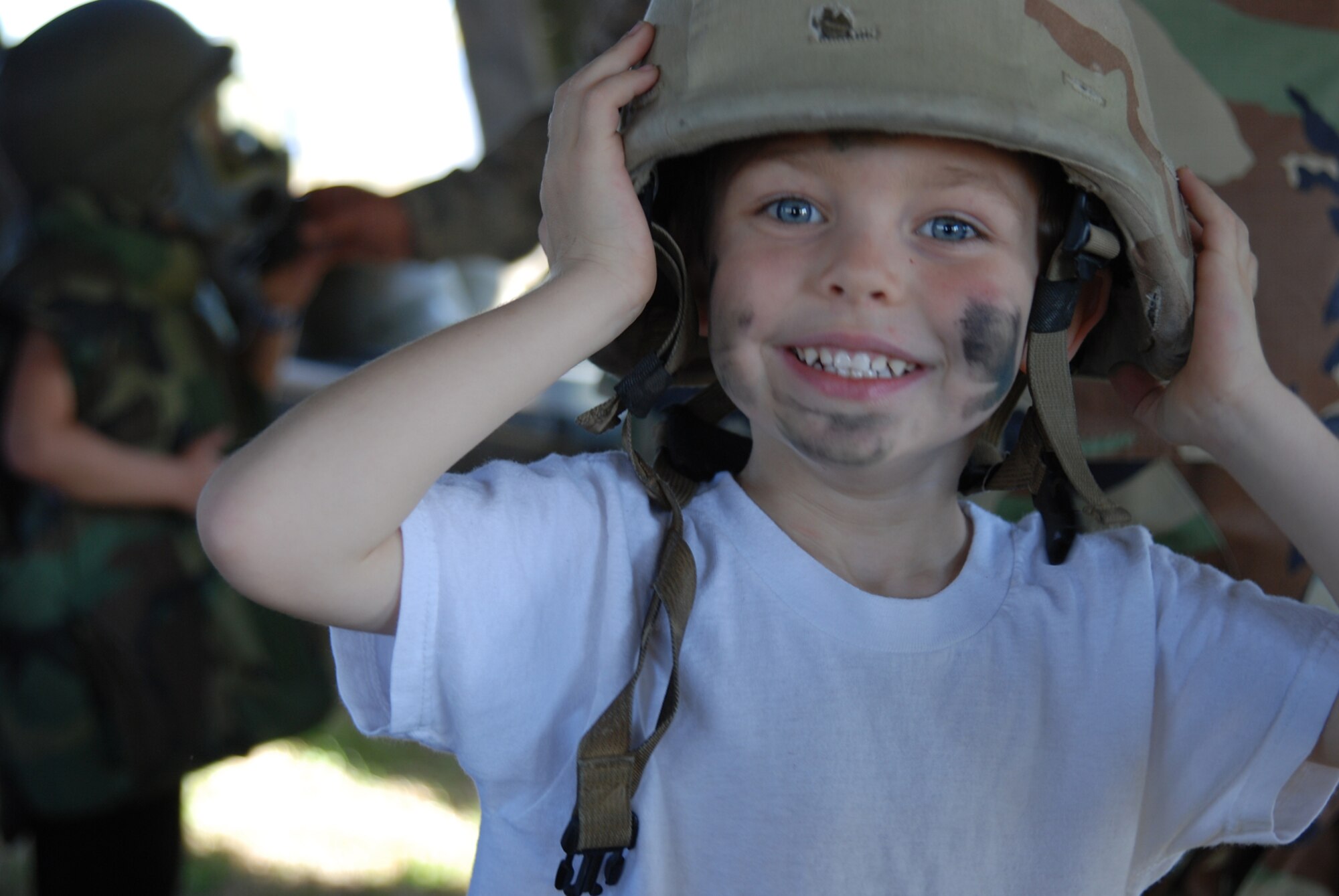 MCCONNELL AIR FORCE BASE, Kan. -- Michael, 3, son of Airman 1st Class Tim Hisey, 22nd Civil Engineering Squadron and wife Courtney, tries on a helmet and combat equipment to learn what gear his father takes with him during deployment, Nov. 1 at the Family Mobility Line. The event is geared to share the deployment process with family members. (Photo by Airman 1st Class Jessica Lockoski)