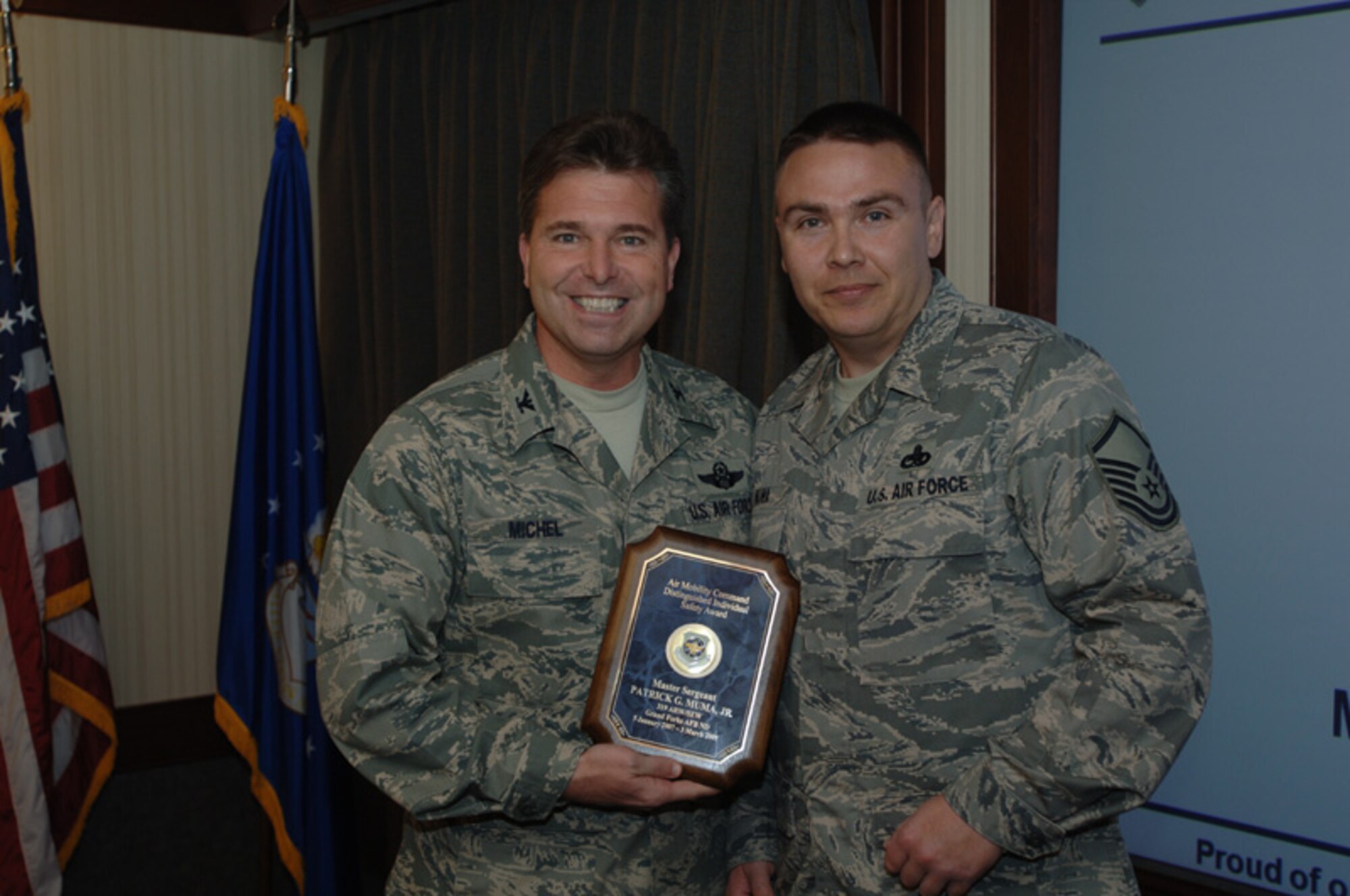 GRAND FORKS AIR FORCE BASE, N.D. -- Master Sgt. Patrick Muma, Jr., 319th Safety Office, is awarded the Air Mobility Command Distinguished Individual Safety Award by Col. John Michel, the 319th Air Refueling Wing commander. Sergeant Muma was selected for the award for his contributions to weapon safety, as well as for his recognition as a superior performer during the 2008 Unit Compliance Inspection. According to Lt. Col. A.D. Davis, 319th Director of Staff, Sergeant Muma took a non-existent weapons program and made it the gem of the command. (photo/Staff Sgt. Suellyn Nuckolls)