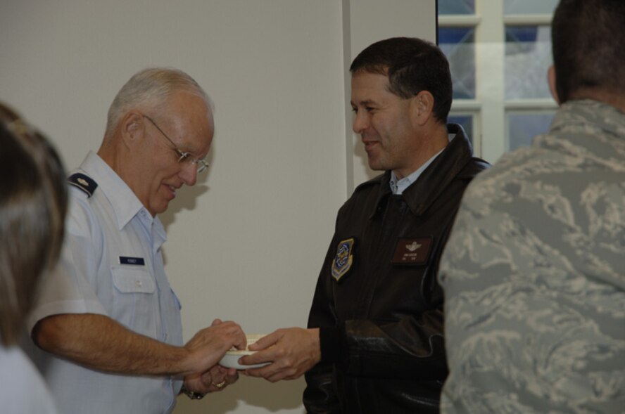Chaplain (Lt. Col.) John Kinney (left), the 319th Air Refueling Wing chaplain, and Col. John Scorsone, 319 ARW vice commander, share popcorn and chat about the possibilities of the newly opened Airmen's Ministry Center. (photo/Airman 1st Class Necole Mullens) 