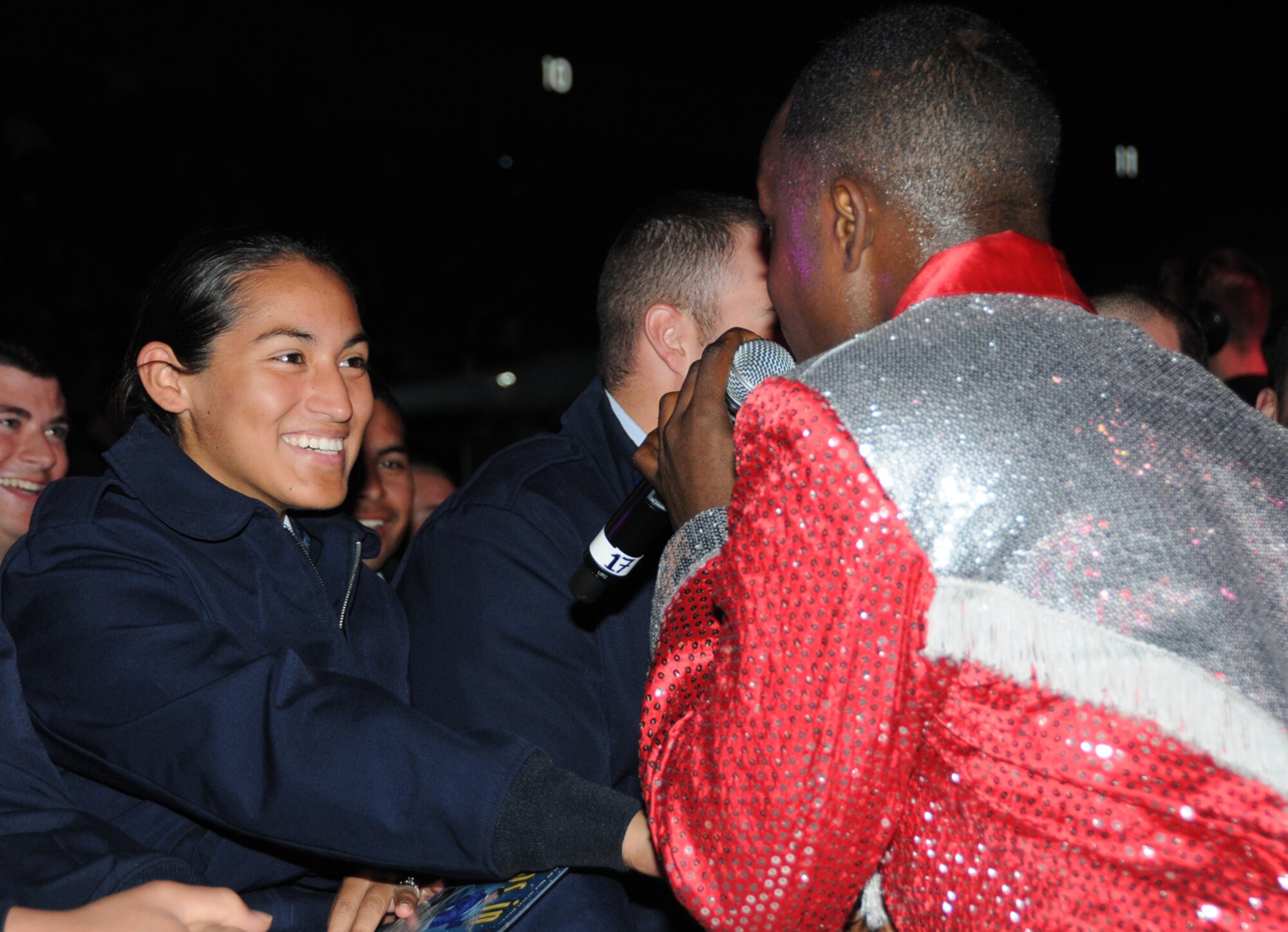 Airman Basic Destiny Ortiz, left, a student in the 334th Training Squadron, is serenaded by Staff Sgt. Corey Sims, Luke Air Force Base, Ariz.  (U.S. Air Force photo by Kemberly Groue)