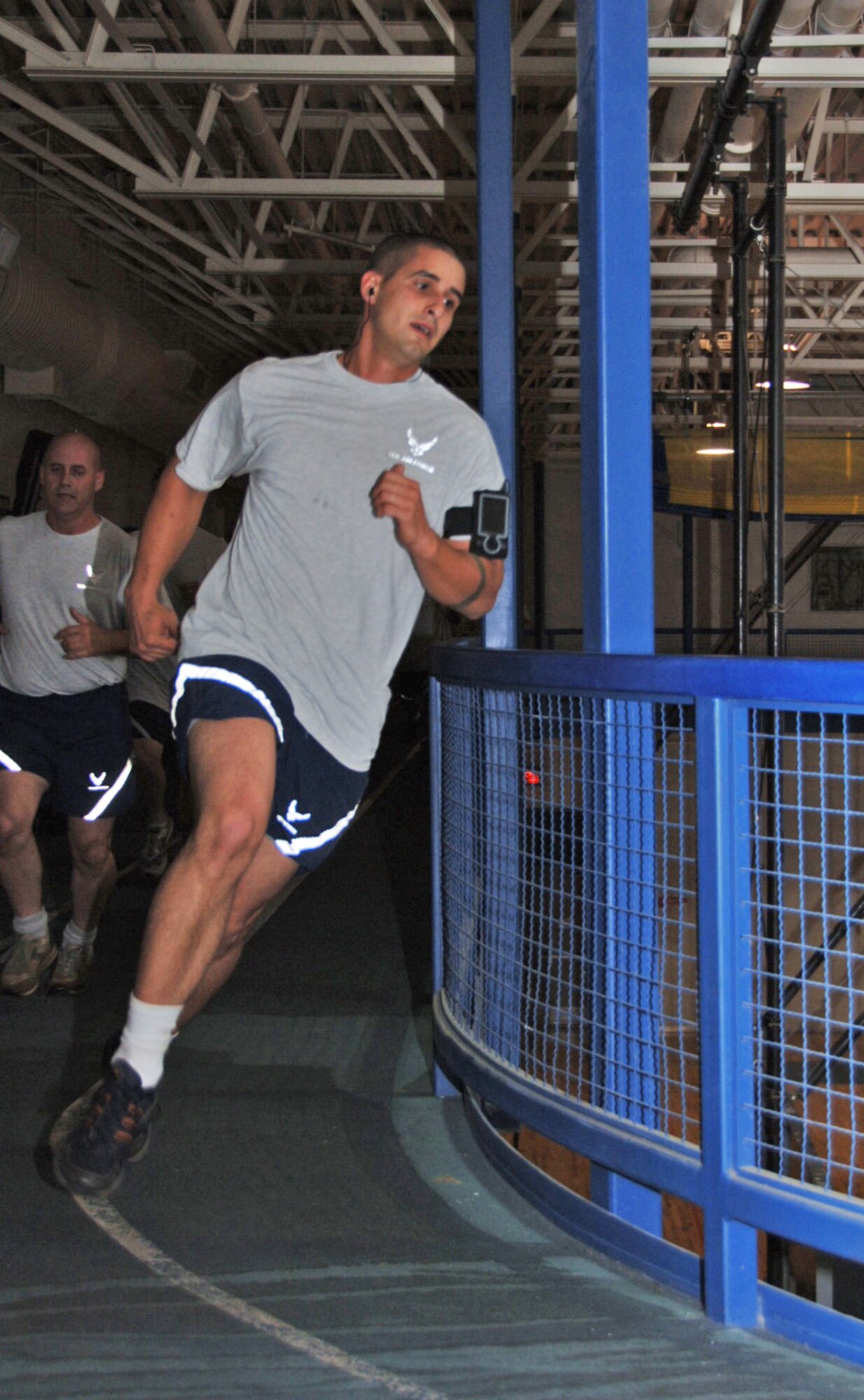 Senior Airman Anthony Ruggles heads into an indoor track turn at the McConnell Air Force Base fitness center during the October Unit Training Assembly of the 931st Air Refueling Group. Airman Ruggles, one of many 931st Airmen forced by bad weather to test their physical fitness indoors during the UTA, received an "Excellent" score for his performance. He is assigned to the 931st's Aircraft Maintenance Squadron, an Air Force Reserve unit at McConnell. (U.S. Air Force photo/Senior Airman Connor Burkhard)