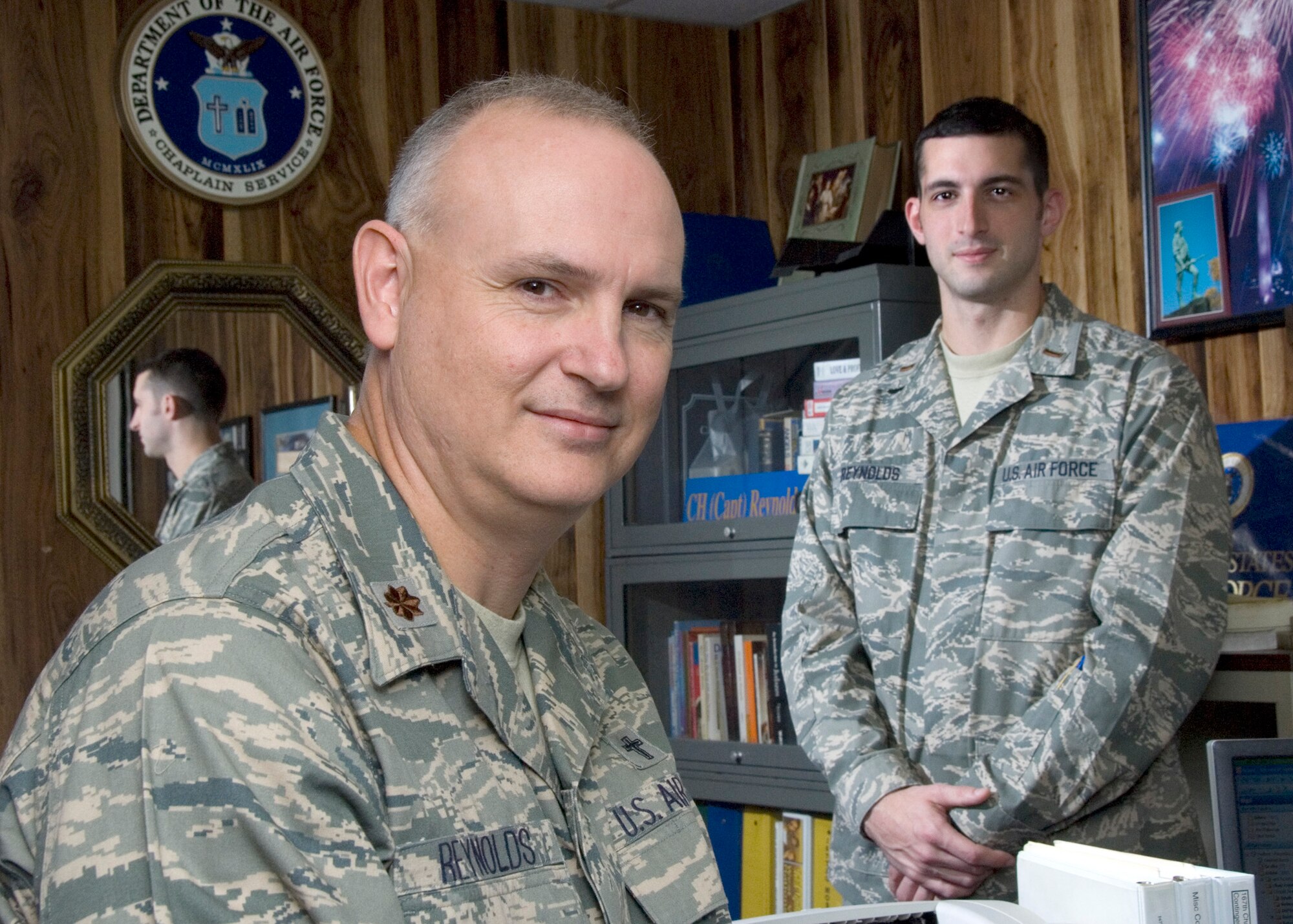 2nd Lt Aaron Reynolds, right, is doing an internship in the 167th Chapel Section, following in the footsteps of his father, Major David Reynolds, 167th Airlift Wing Chaplain. Reynolds was a member of the 167th Airlift Wing, but has transferred to the Air Reserves to participate in the chaplain candidate program. (U.S. Air Force photo by MSgt Emily Beightol-Deyerle)