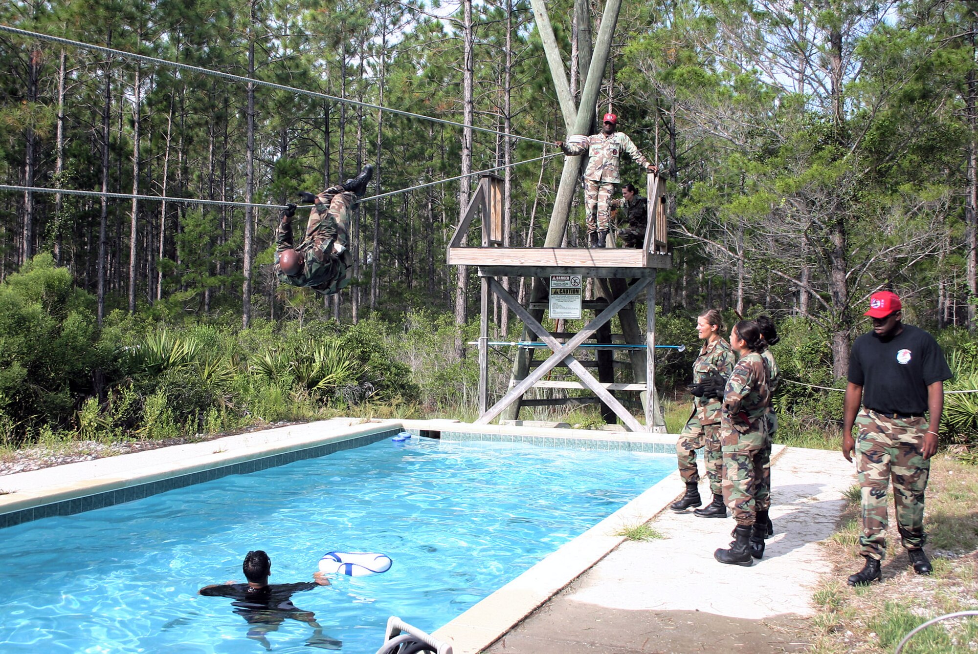 Tech. Sgt. Don White attempts the last of the 13 stations on the 823rd RED HORSE Squadron's obstacle course during a Silver Flag exercise at Tyndall Air Force Base, Fla. (U.S. Air Force photo/Richard Salomon) 
