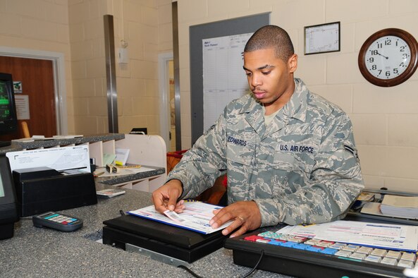 Airman 1st Class Antonio Edwards prepares express mail for the presidential elections Nov. 4. The post office offered a free express mail service Oct. 29 to Nov. 4 for all election ballots. (U.S. Air Force photo by Karen Abeyasekere)