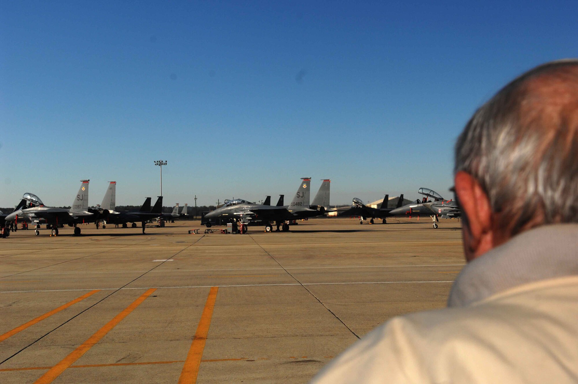 Korean War veteran Joseph Lynch, a former F-86 pilot, looks out to the ramp where the F-15E Strike Eagle aircraft sit instead of the F-86s he is used to seeing at Seymour Johnson Air Force Base N.C., Oct. 31. This is the first time since 1954 that Mr. Lynch has stepped foot on a military instillation. (U.S. Air Force Photo by Airman 1st Class Rae A. Perry)