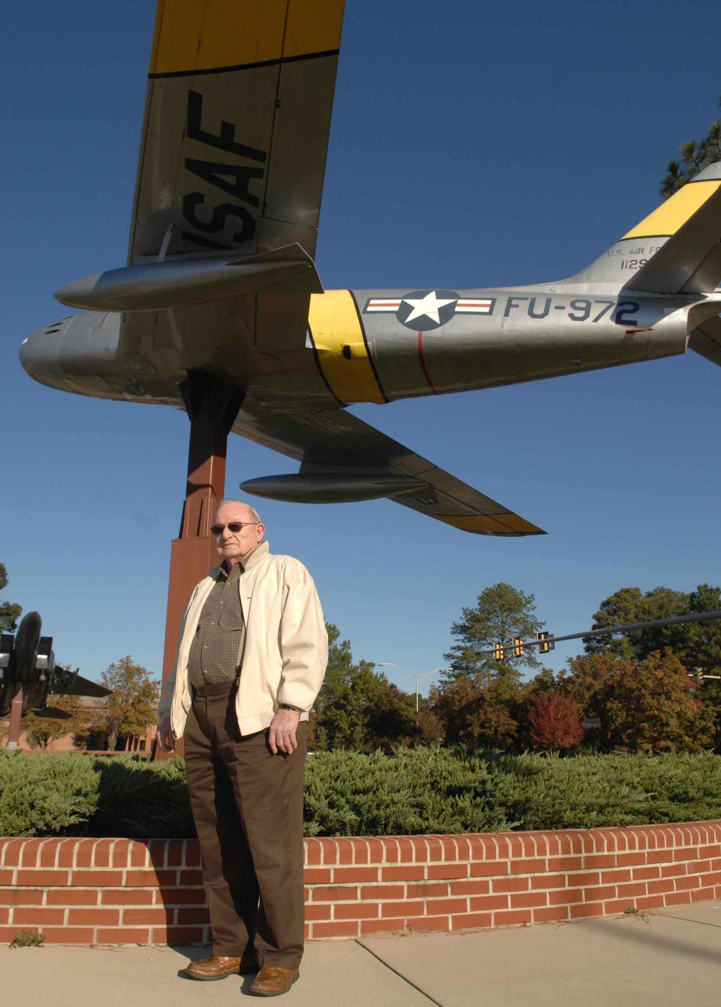 Joseph Lynch, a former F-86 pilot and veteran of the Korean War, stands in front of the static display of an aircraft he flew during his time in the Air Force during his visit to Seymour Johnson Air Force Base N.C., Oct.  31. This is the first time in 54 years that Mr. Lynch has stepped foot on a military instillation. (U.S. Air Force Photo by Airman 1st Class Rae A. Perry)