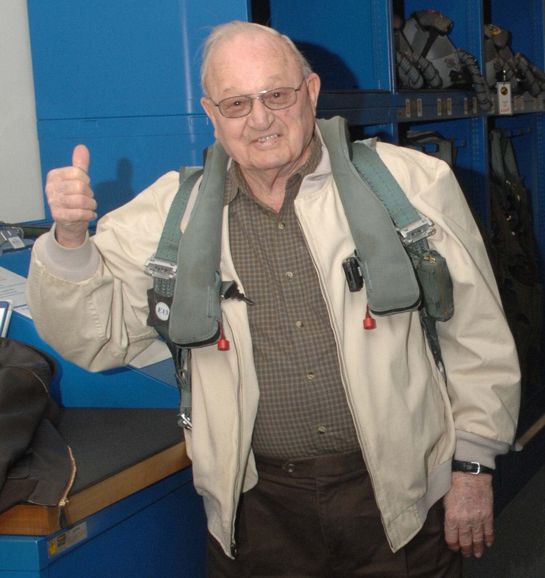 Joseph Lynch, an F-86 pilot and  Korean War veteran, gives the thumbs up sign while trying on a flight vest at the 334th Fighter Squadron at Seymour Johnson Air Force Base, N.C.  For Mr. Lynch’s 80th birthday, he wanted to see how much the military has changed in the 54 years after his separation. (U.S. Air Force Photo by Airman 1st Class Rae A. Perry)