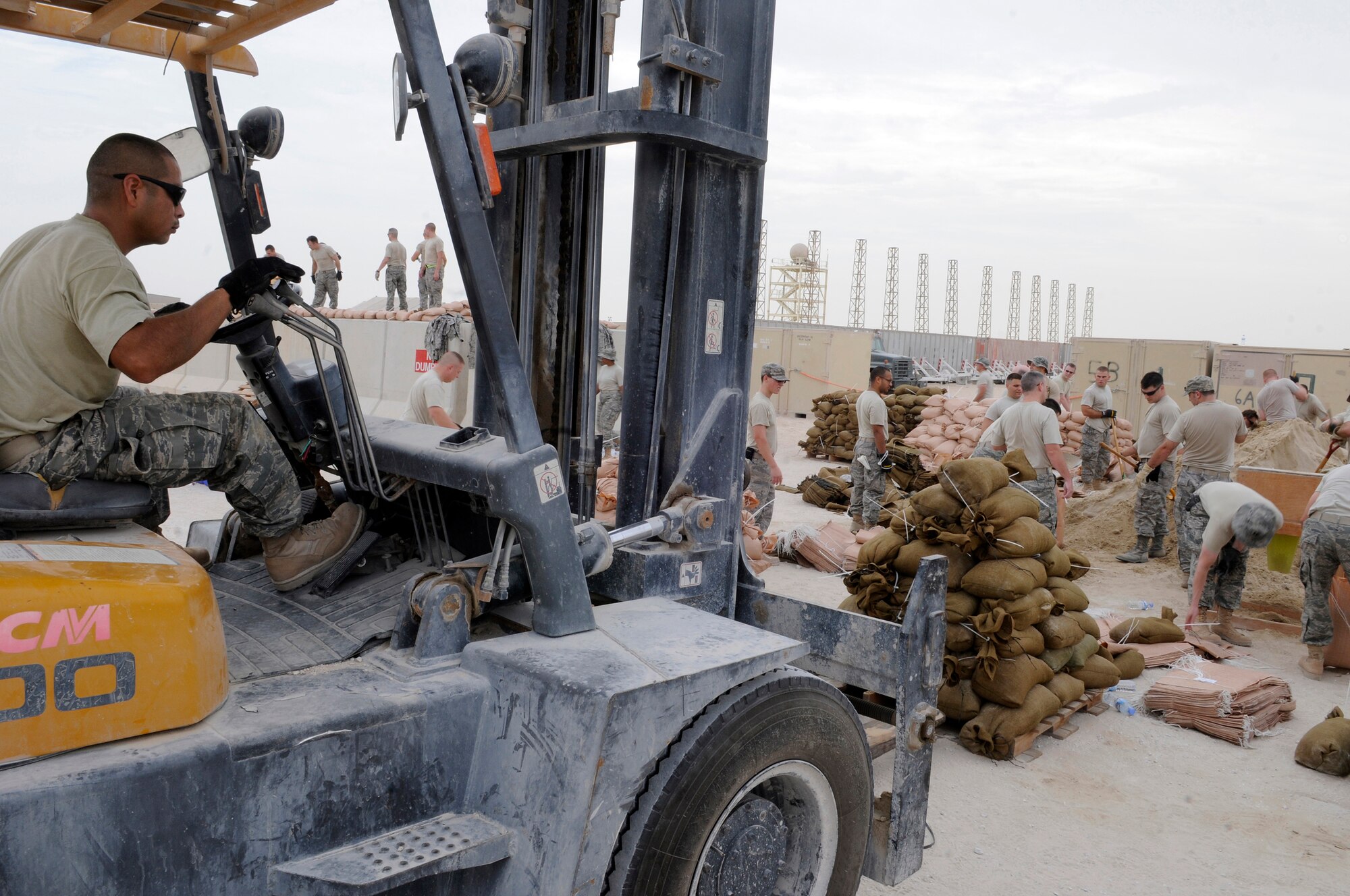 Staff Sgt. Ramon Alvarez, 379th Expeditionary Communications Squadron, manipulates an 8K forklift picking up a pallet of sandbags, Nov. 4, at an undisclosed air base in Southwest Asia.  The sand bags will be lifted to the top of new emergency bunkers to increase fortification.  Sergeant Alvarez, a native of San Antonio, Texas, is deployed from Lackland Air Force Base, Texas, in support of Operations Iraqi and Enduring Freedom and Joint Task Force-Horn of Africa.  (U.S. Air Force photo by Tech. Sgt. Michael Boquette/ Released)