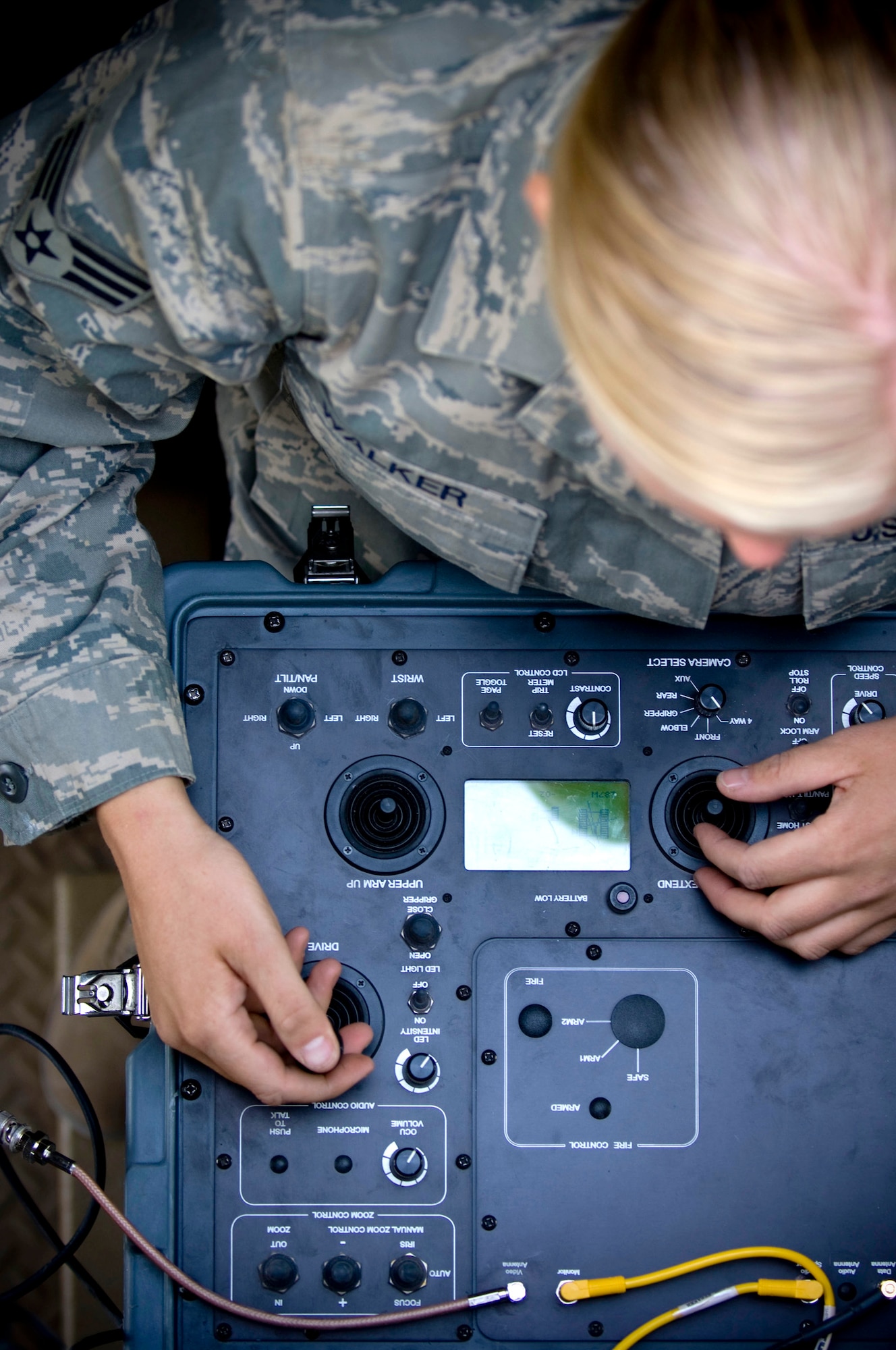 Senior Airman Emily Walker, 755th Air Expeditionary Group Explosive Ordnance Disposal Operation Location-Bravo, pilots a Talon EOD robot from inside a mine-resistant, ambush-protected vehicle at Kandahar Air Field, Afghanistan, Oct. 26. Integrated cameras allow Airman Walker to see objects around the robot, helping her to safely handle most incidents without ever having to leave the MRAP. Airman Walker is deployed from Ramstein Air Base, Germany, and hails from Brownsville, Calif. (U.S. Air Force photo by Staff Sgt. Samuel Morse/Released)