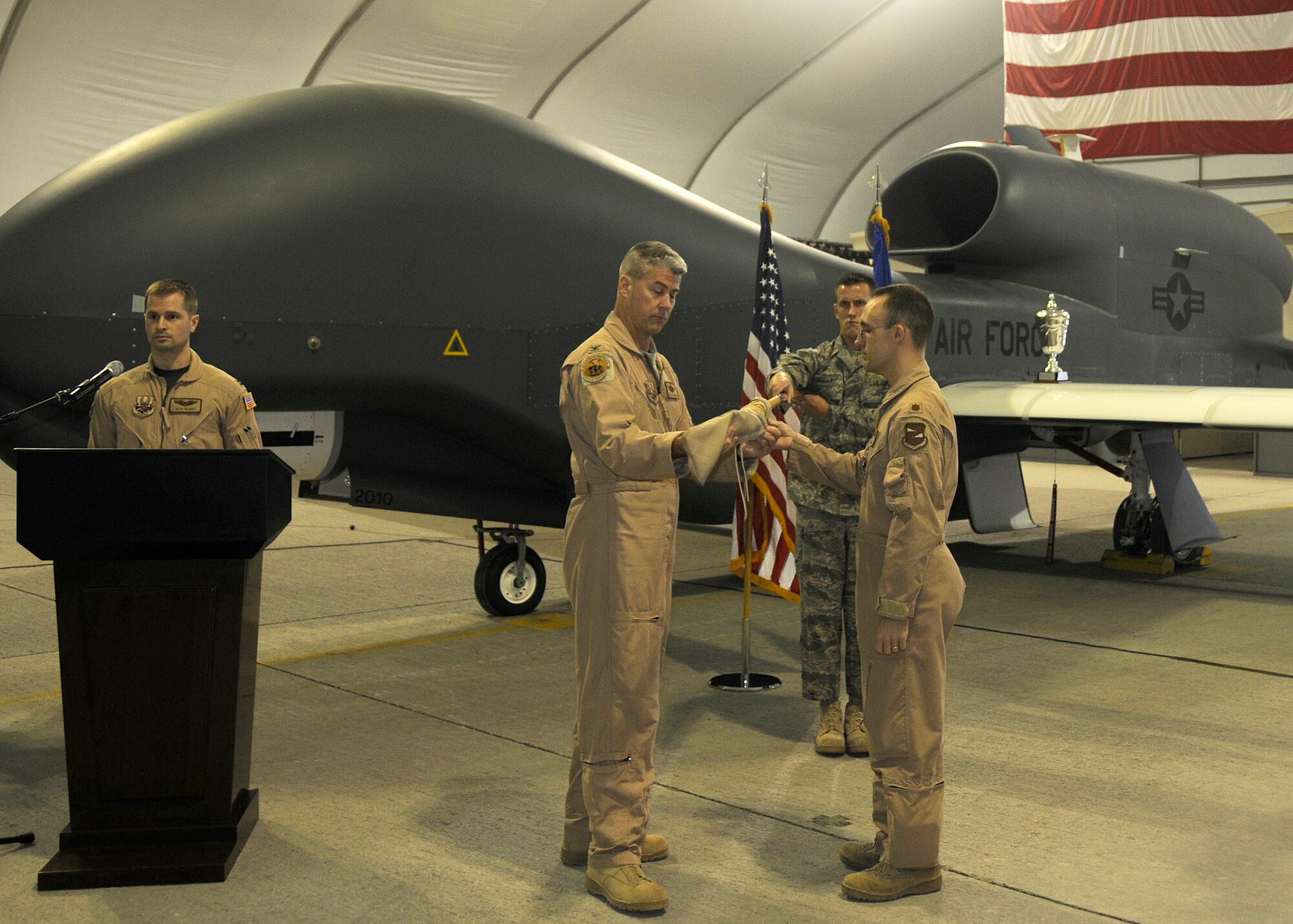 SOUTHWEST ASIA -- Maj. Robert Matlock (right), 12th Expeditionary Reconnaissance Squadron commander, and Col. Kyle Garland, 380th Expeditionary Operations Group commander, case the guide-on as part of the inactivation ceremony here Nov. 1. The 12th ERS inactivated, but is not going far. The assets and mission have been picked up by the 99th ERS. (U.S. Air Force photo/Tech. Sgt. Christopher A. Campbell)(released)