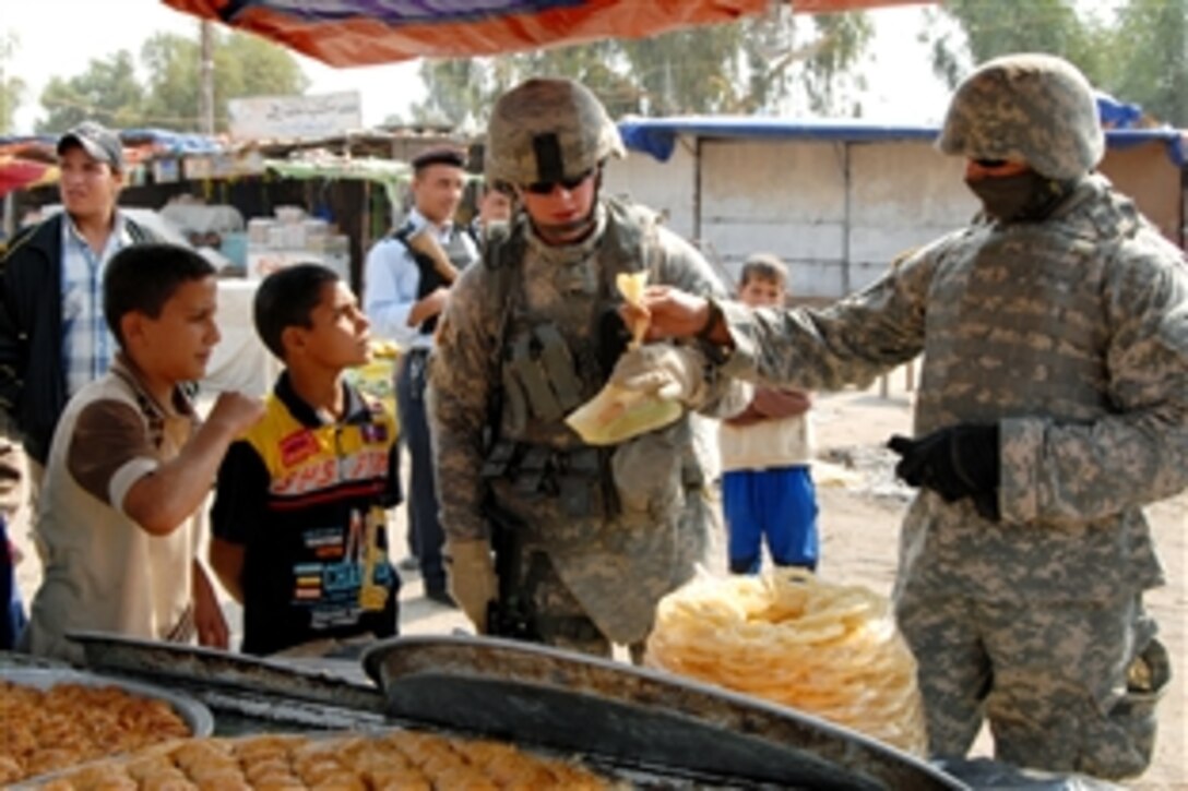 U.S. Army Spc. Hardin stops to buy food from a market in Jabella, Iraq, Oct. 31, 2008. Hardin is assigned to the 230th Military Police Company, 793rd Military Police Battalion, 18th Military Police Brigade Combat Team.