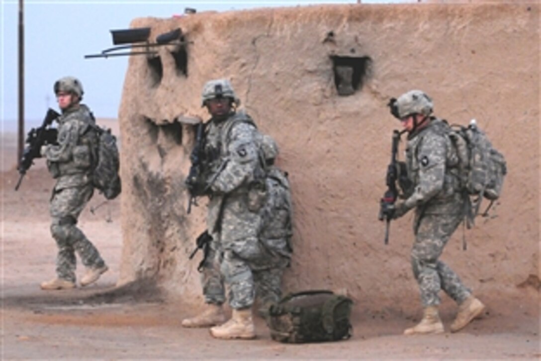 U.S. Army soldiers prepare to move to their next target house as they sweep a small village during Operation Syme in Tikrit, Iraq, Oct. 28, 2008. The soldiers are assigned to the 101st Airborne Division's Company B, 1st Special Troops Battalion, 1st Brigade Combat Team. Operation Syme is an air assault operation targeting insurgent fighters in the desert areas west of Tikrit. 