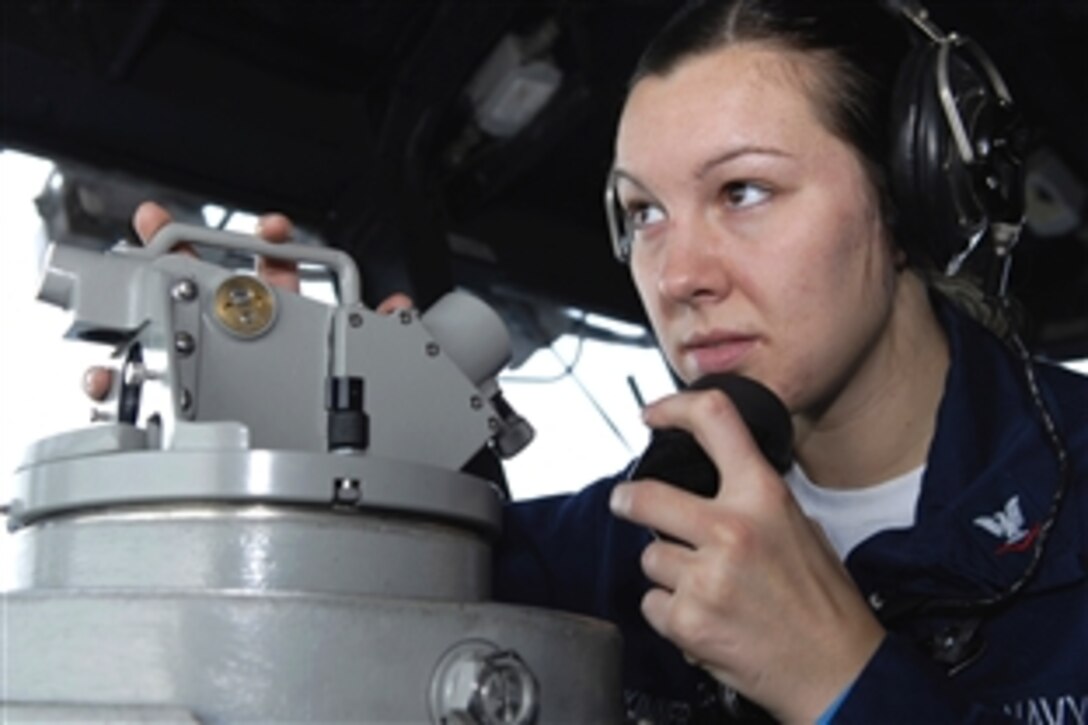 U.S. Navy Petty Officer 3rd Class Cindy R. Skinner uses a telescopic alidade to make reports on surface contacts aboard the amphibious assault ship USS Essex in the Pacific Ocean, Nov. 5, 2008. The USS Essex is the lead ship of the only forward-deployed U.S. Expeditionary Strike Group. Skinner is an operations specialist.