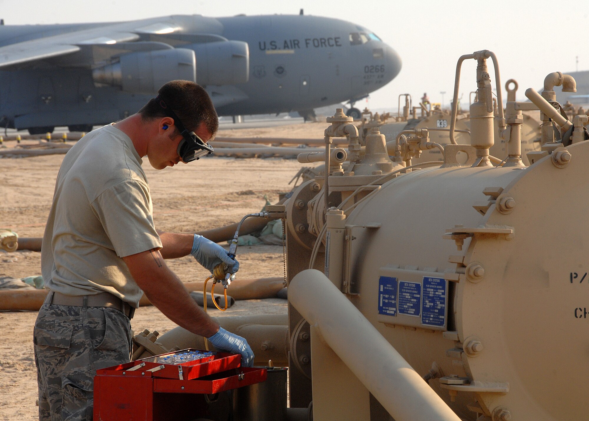 SOUTHWEST ASIA -- Staff Sgt. Michelangelo Serio, 386th Expeditionary Logistics Readiness Squadron Fuels Management Flight, takes fuel samples from a FORCE Fuel machine on Nov. 4 at an air base in Southwest Asia. Sergeant Serio is deployed from Aviano Air Base, Italy. (U.S. Air Force photo/Tech. Sgt. Raheem Moore)