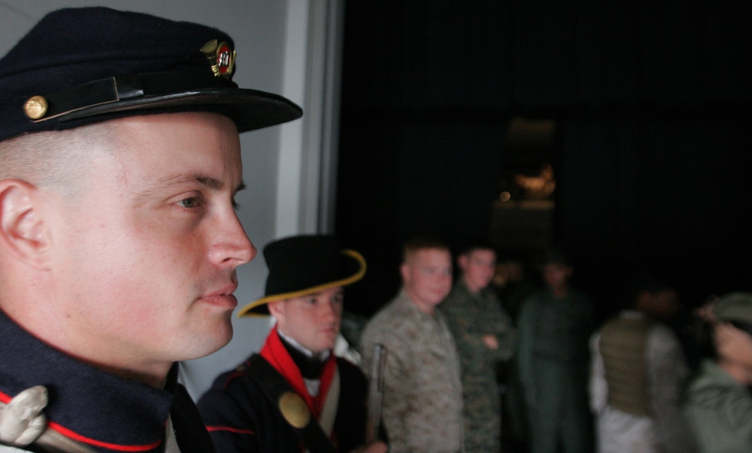 Sgt. Zach J. Forsythe, 1st Intelligence Battalion, Marine Corps Base Camp Pendleton, wears his own World War II Marine Corps uniform while preparing to go on the base theatre's stage where service members celebrate the Corps' 233rd birthday Tuesday.