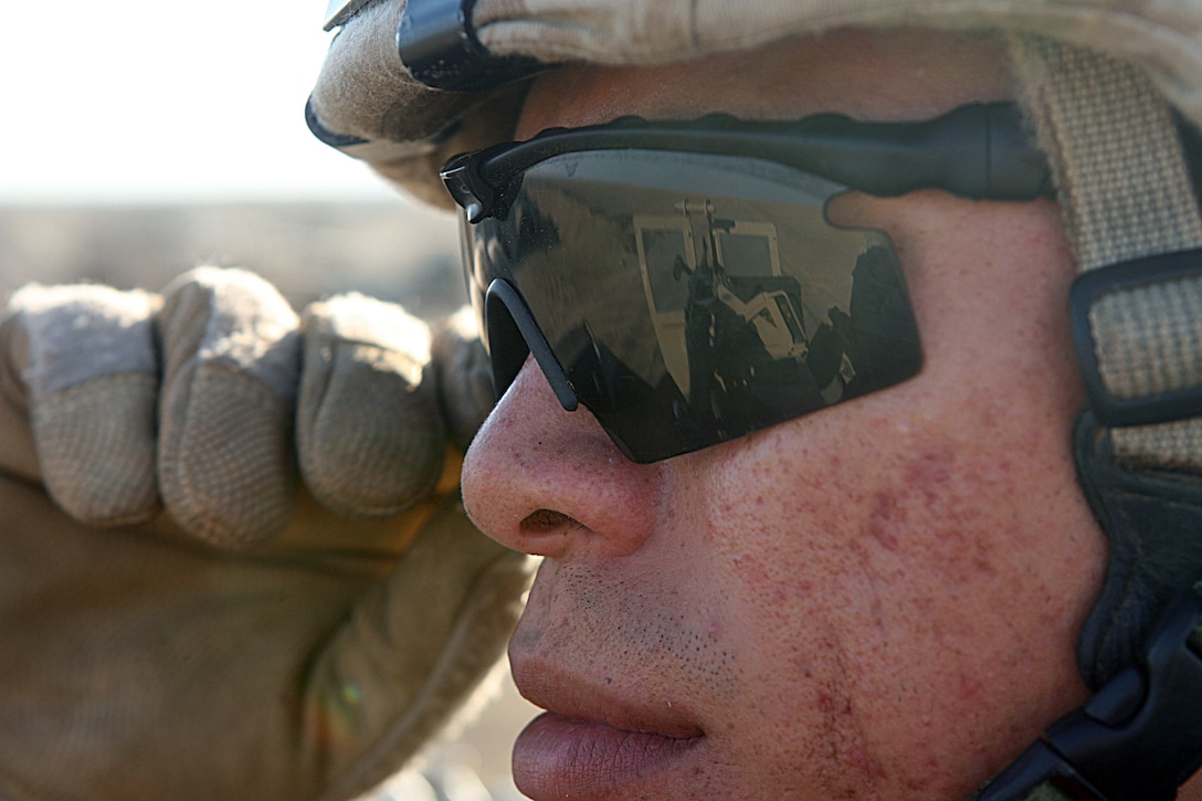 Lance Cpl. Joeli O. Noareyes, a military policeman with MP Detachment, Combat Logistics Company 19, 1st Marine Logistics Group maintains a watchful eye over his particular section of Camp Sinjar’s perimeter Nov. 6. Noareyes, 23, Santa Isabel, Puerto Rico, and the other MPs with the detachment are responsible for base security, entry control point security and patrols through neighboring towns. Base security here consists of Military Police posted up in armored vehicles with mounted machineguns. MPs positioned the vehicles at strategic locations around the perimeter, based on fields of fire and weapons’ capabilities. If the machineguns and the occasional patrols don’t dissuade insurgents from causing problems, then the MP Quick Reaction Force provides another tool for thwarting enemy goals. A small, platoon-sized QRF element can react to anything from rapidly approaching vehicles to squad sized attacks and base infiltrations. The QRF can also call upon close-air support and the sizable ground combat element to help shore up any larger-scale problems. The MPs here operate in support of Operation Defeat Al Qaeda North II, an operation designed to help Coalition forces restore stability to the restive city of Mosul.
