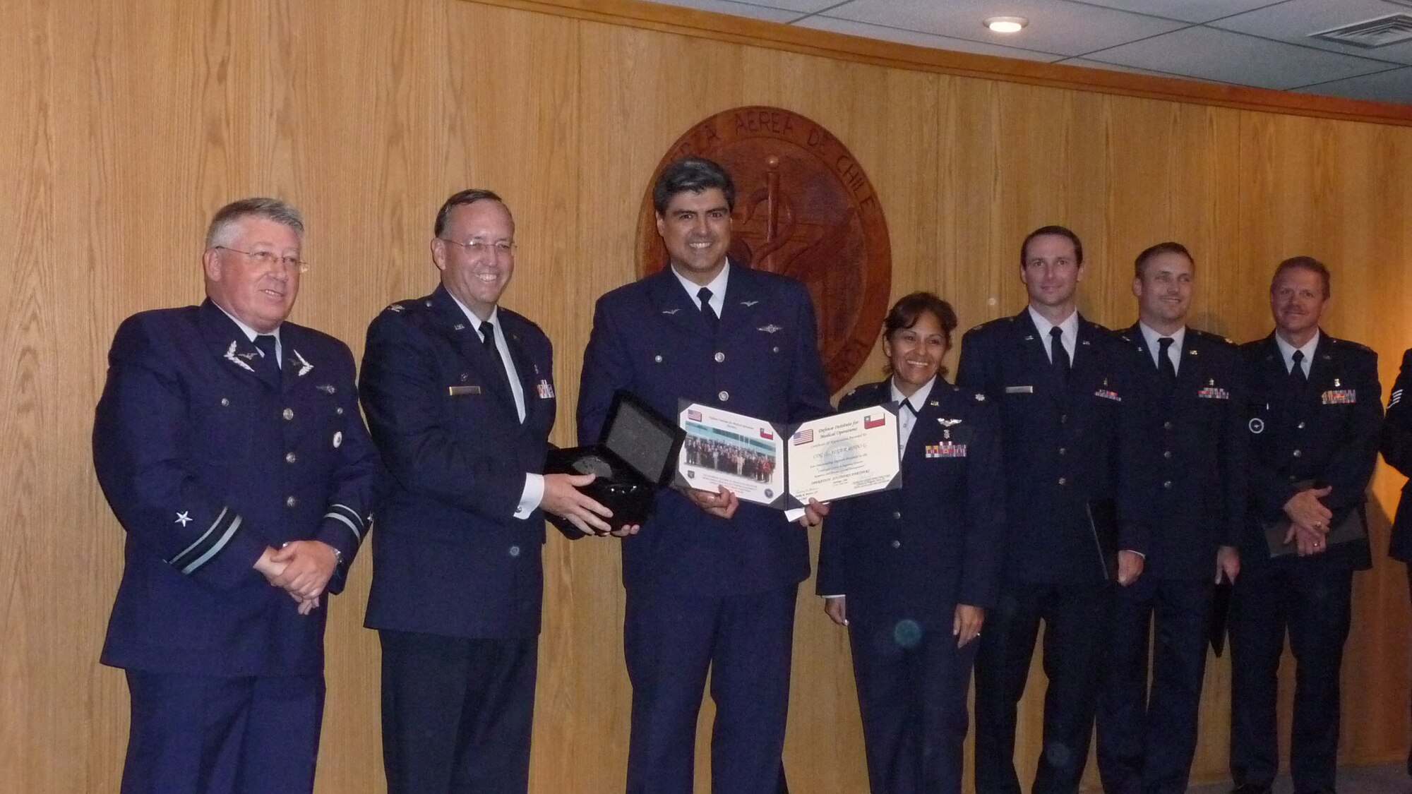 Lt. Col. Alger Rodó, chief of operative medicine with the Chilean Air Force, poses with members of the Defense Institute for Medical Operations during the graduation ceremony from the multi-national disaster response course on 4 Nov.  The Defense Institute for Medical Operations course is part of Operation Southern Partner; an AFSOUTH-led event aimed at providing intensive, periodic subject matter exchanges with partner nations in the U.S. Southern Command area of focus.  The all-new program features more than 70 U.S. Air Force subject matter experts from about 25 career fields working alongside partner nation military members in similar career specialties during week-long exchanges.  The next morning, Colonel Rodó led a tour of his hospital’s emergency room for U.S. Air Force doctors.  Later, Air Force doctors were able to sit in on a lecture where Chilean doctors evaluated different courses of action to treat patients.  (Photo  by Capt. Nathan D. Broshear)