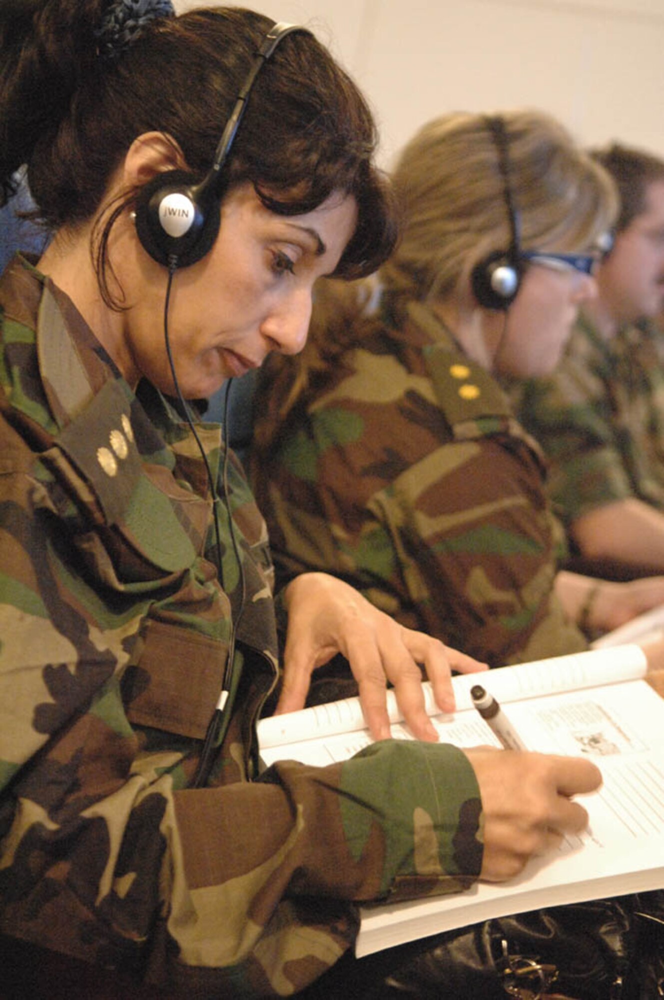 Uruguayan military nurses take notes while listening to the Spanish translation of a presentation given by members of the US Defense Institute for Medical Operation while participating in an exchange during Operation Southern Partner, Nov., 3, 2008. OSP is an in-depth, two-week subject matter exchange emphasizing partnership, cooperation and sharing of information with partner nation Air Forces in Latin America. 
(U.S. Air Force Photo by TSgt Roy Santana, Released)