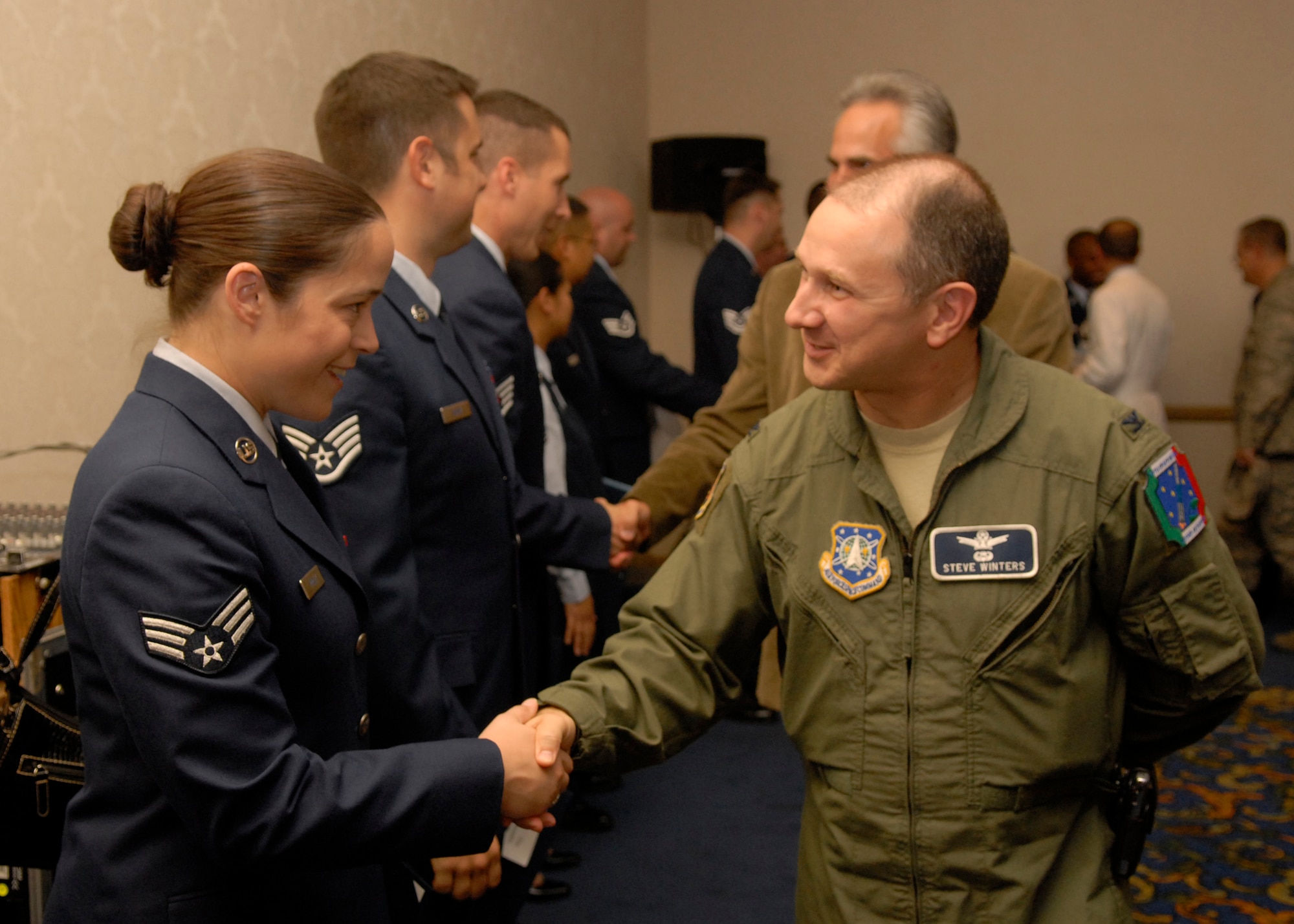 VANDENBERG AIR FORCE BASE, Calif. --  Col. Steven Winters, 30th Space Wing vice commander, congratulates Airmen after they recieve their Community College of the Air Force diploma. For those Airmen interested in achieving their CCAF degree, the base education center here is scheduled to host a CCAF counseling session in the student lounge Oct. 2, beginning at 1 p.m.  (U.S. Air Force photo / Airman 1st Class Andrew Satran)