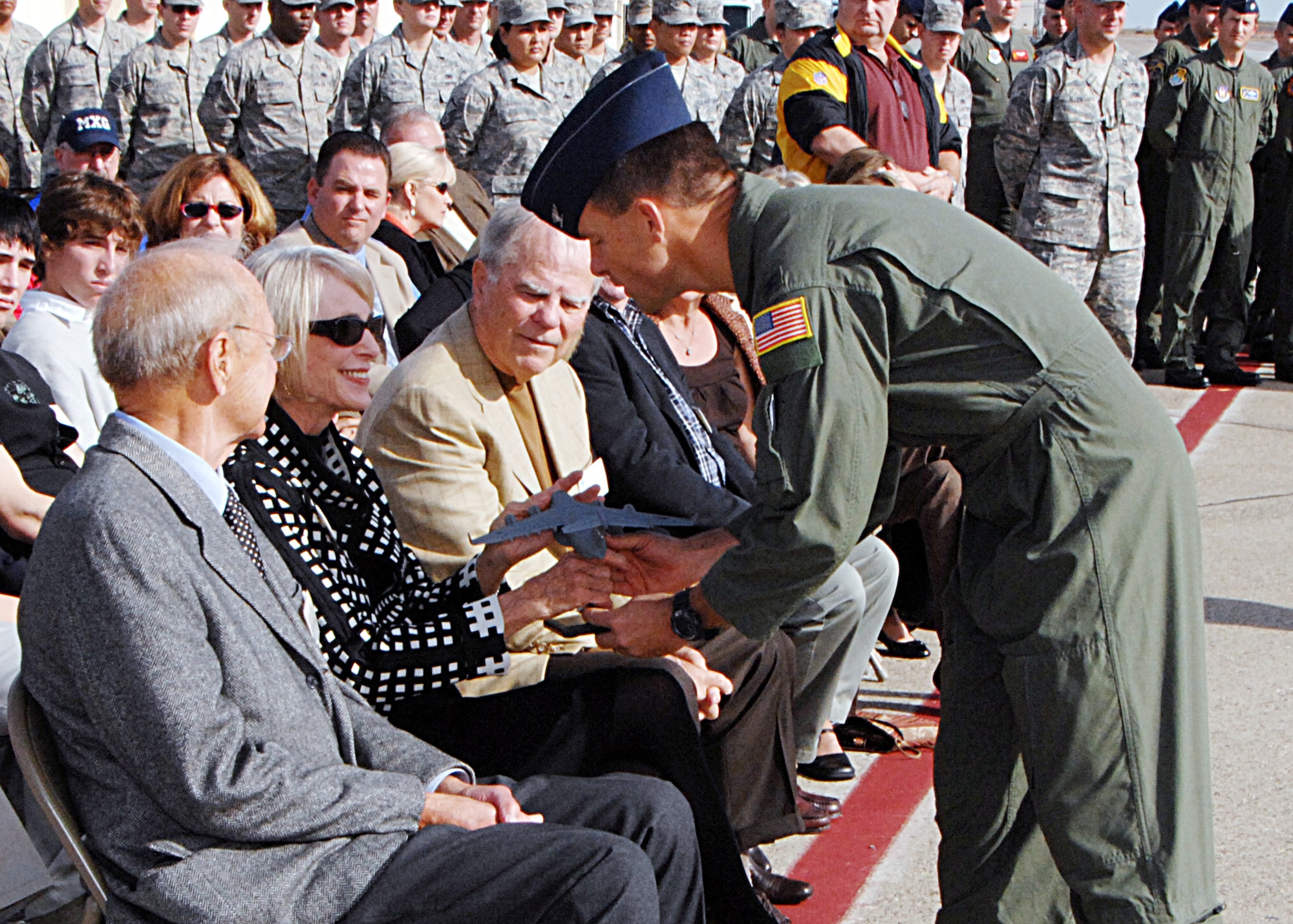 Col. Mark Dillon, 60th Air Mobility Wing commander, presents a model of a C-17 Globemaster III to members of Brig. Gen. Robert Travis' family who came to Travis Air Force Base to witness the arrival of the final C-17 "The Spirit of Travis." (U.S. Air Force photo/Dave Cushman)