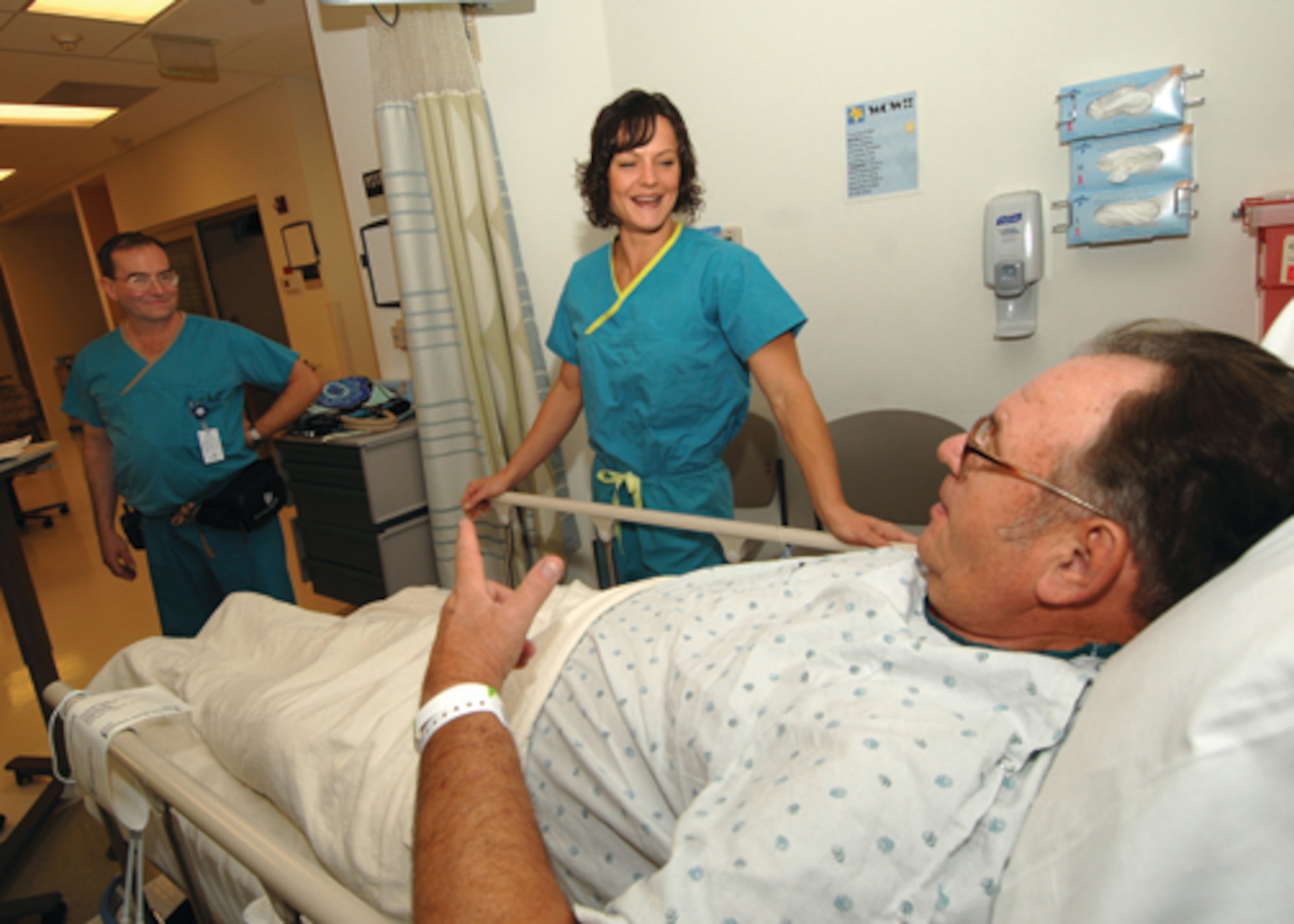 Maj. (Dr.) Kristin Warner, 56th Medical Operations Squadron orthopedic surgeon, meets with retiree Okey Kriner shortly before beginning his knee-replacement surgery at Banner Estrella Hospital. (U.S. Air Force photo/ Tech. Sgt. Jeffery Wolfe.)