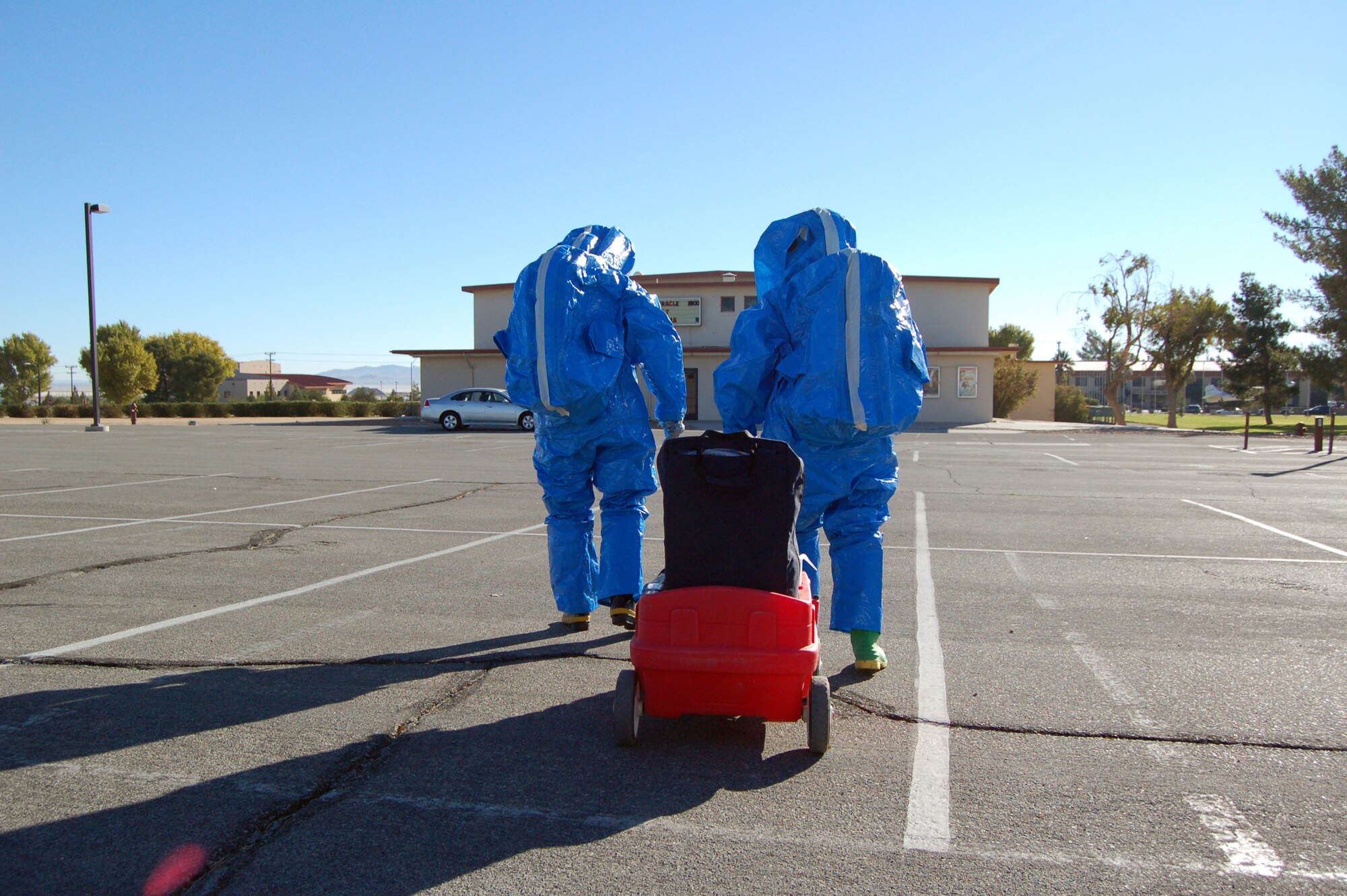 Staff Sgt. Amanda Lublin and Senior Airman Anthony Particini, 95th Aerospace Medicine Squadron bioenvironmental flight industrial hygiene technicians, respond to a scenario at the base theater Nov. 6 as part of Chemical, Biological, Radiological and Nuclear Challenge. The four-day event includes training on sampling and detection equipment and responding on five scenarios for the challenges. Some of these scenarios include suspicious package in the mailroom and biological contamination inside a car. (Air Force photo by Senior Airman Julius Delos Reyes)