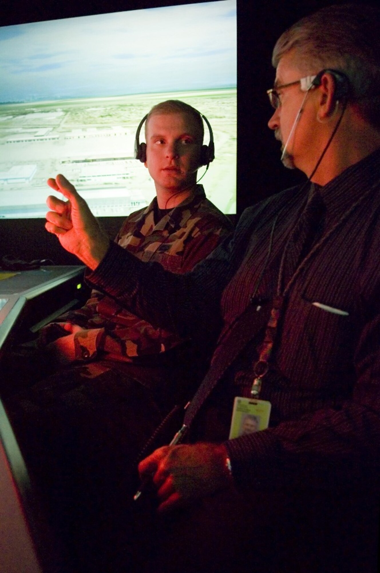 Sea-Tac frontline manager Todd Thomas, right, talks with Airman 1st Class Loren Cameron, 62nd OSS, in the control tower simulator here Nov. 6. (U.S. Air Force photo/Abner Guzman)