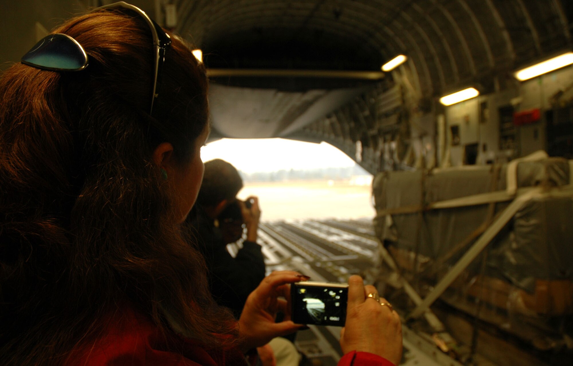 Carol O'Leary, president and chief executive officer of the Challenger Learning Center and a civic leader from Colorado Springs, Colo., gets ready to capture an image of a C-17 Globemaster III combat off load Oct. 30 at McChord Air Force Base, Wash. A group of 25 civic leaders were sponsored by the 302nd Airlift Wing during a community relations tour to the Northwest base, where they learned more about the Air Force Reserve mission. The 302nd AW is based out of Peterson AFB, Colo. (U.S. Air Force photo/Senior Airman Stephen Collier)
