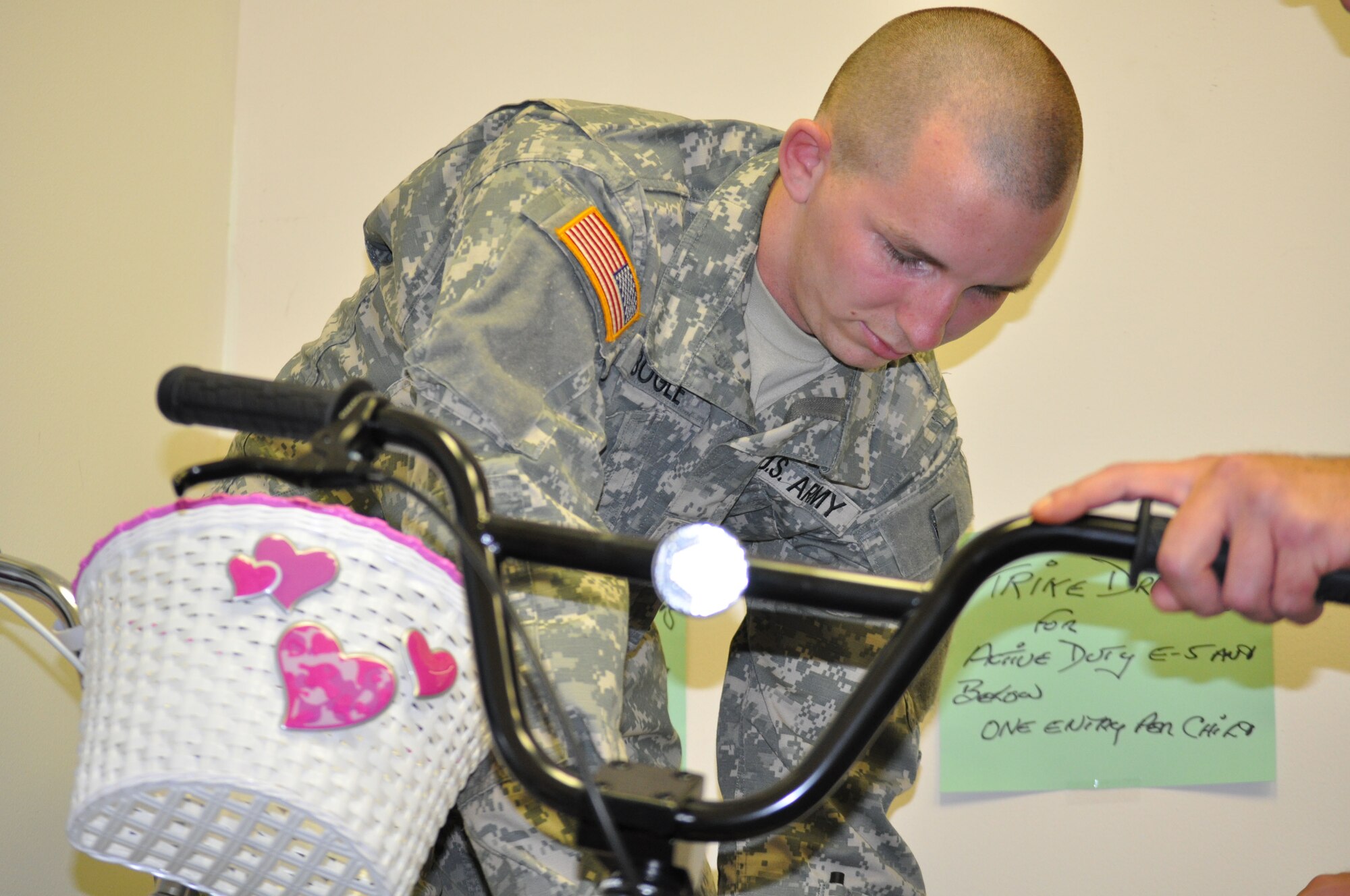 EGLIN AIR FORCE BASE, Fla. -- Pfc. Brandon Bogle, a Soldier in advanced individual training at the Explosive Ordnance School here, collects donations at the Airman's Attic and helps redistribute them within the store. (U.S. Air Force photo/Airman Chris Jacobs)