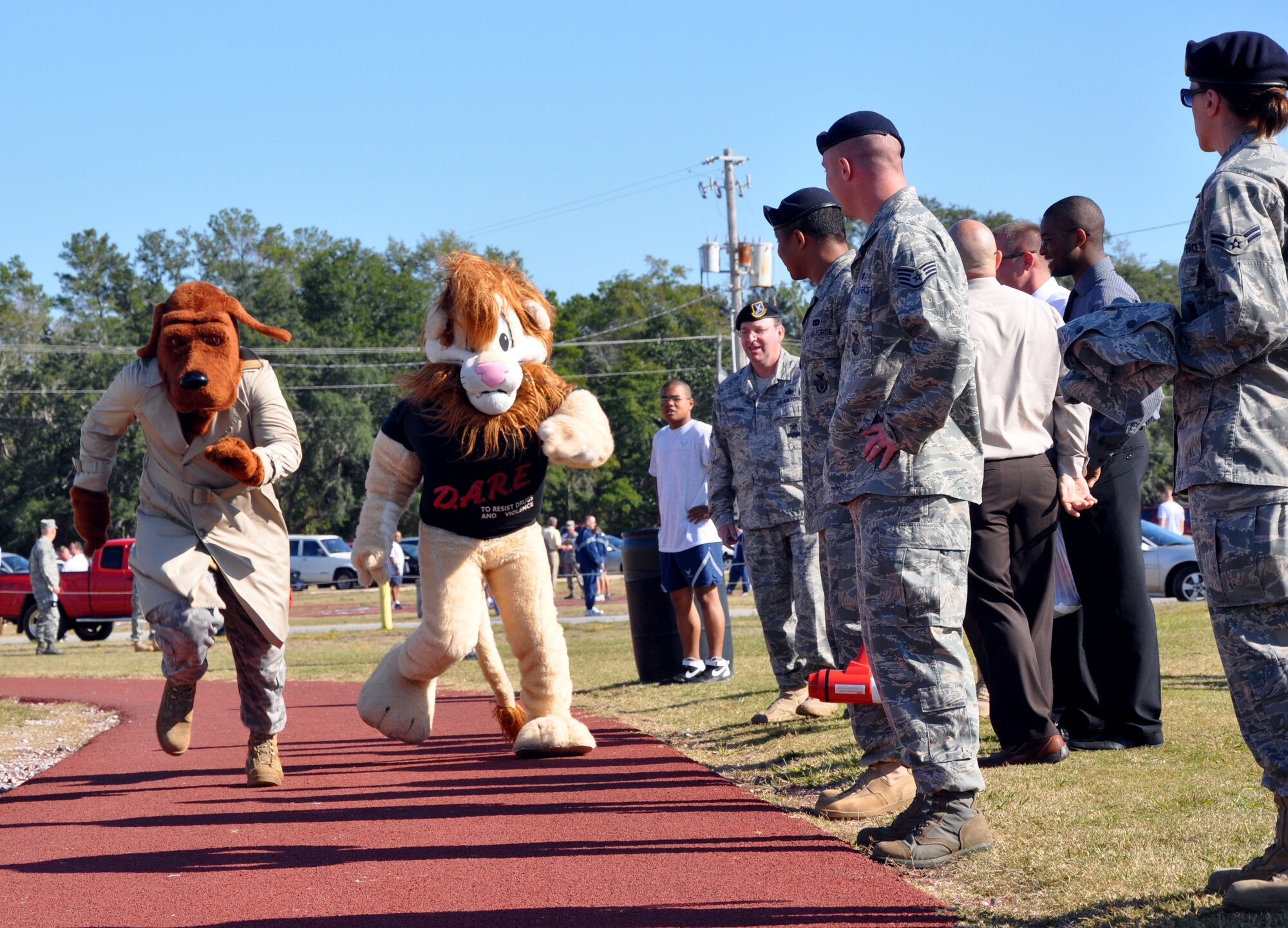 EGLIN AIR FORCE BASE, Fla. -- Left, McGruff the Crime Dog and the D.A.R.E Lion run a foot race at the Wingman Day activities Nov. 6 at Foster Stadium. (U.S. Air Force photo/Staff Sgt. LuCelia Ball)