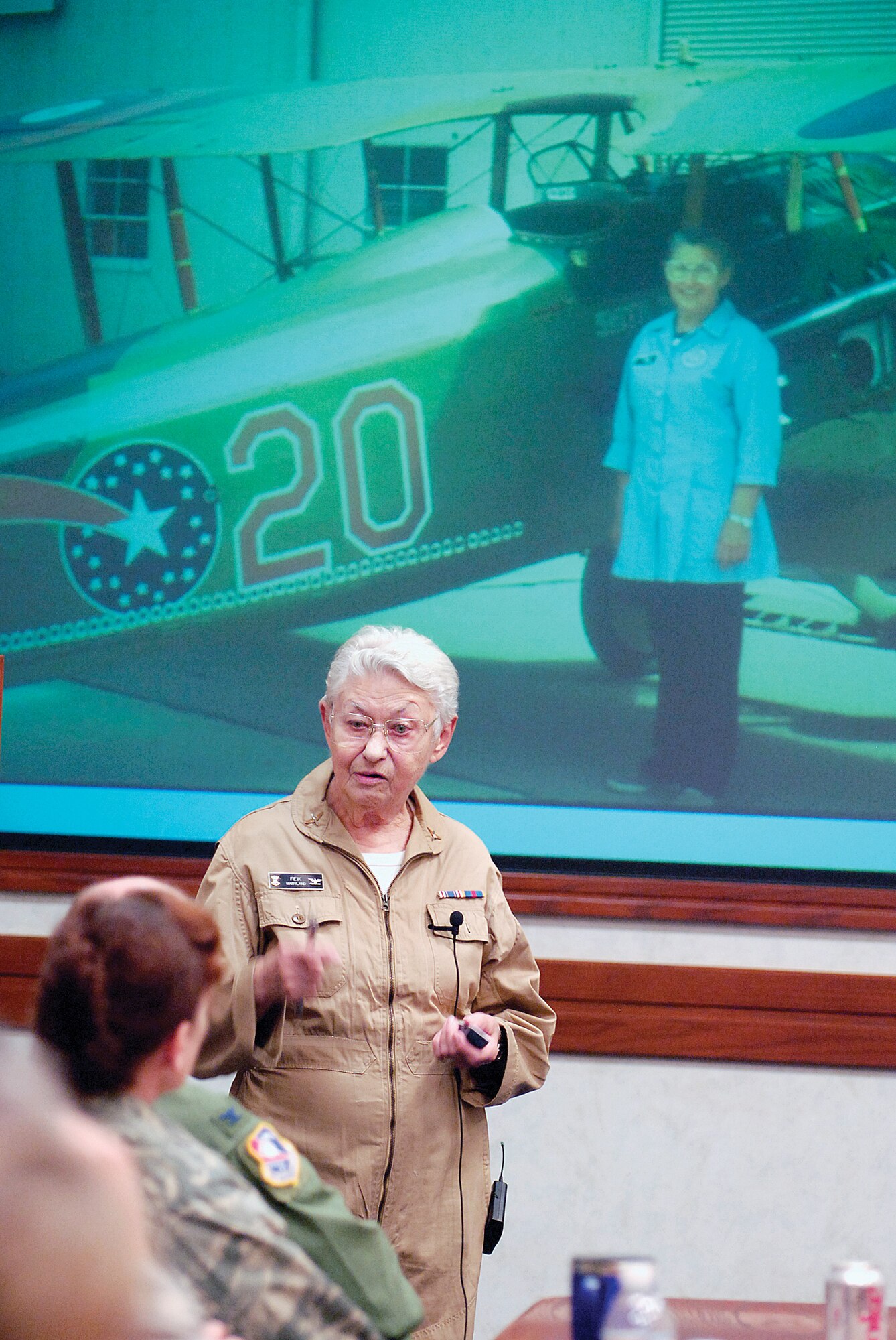 Civil Air Patrol Col. Mary Feik shows images from her early aviation career during her presentation to Tinker leaders at the Oct. 30 Senior Leader Forum in Bldg. 3001.  With more than 60 years of flying, fixing and building aircraft and teaching, the aviator told stories of learning from her father and from sergeants who didn’t let her gender or age keep them from mentoring her. (Air Force photo/Margo Wright)