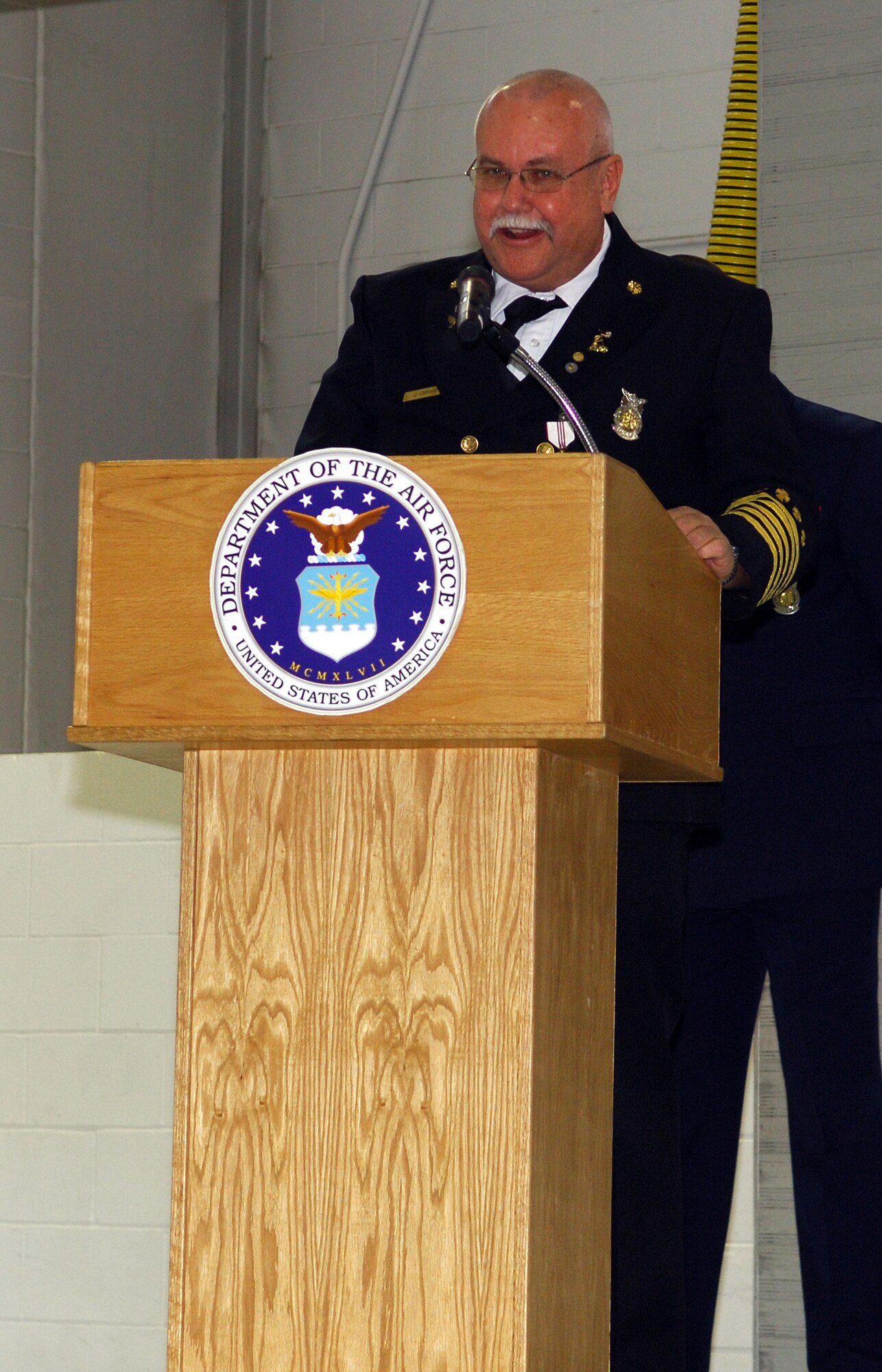MINOT AIR FORCE BASE, N.D. -- Fire Chief James D. Clifford takes the podium to give a speech during his retirement ceremony here Oct. 31. Chief Clifford was selected as base fire inspector in March 1986, promoted to Assistant Chief of Fire Prevention in 1992 and selected as Fire Chief in July 2001. Chief Clifford has dedicated 33 years of his life toward faithful service to his country and community. (U.S. Air Force photo by Senior Airman Cassandra Jones)