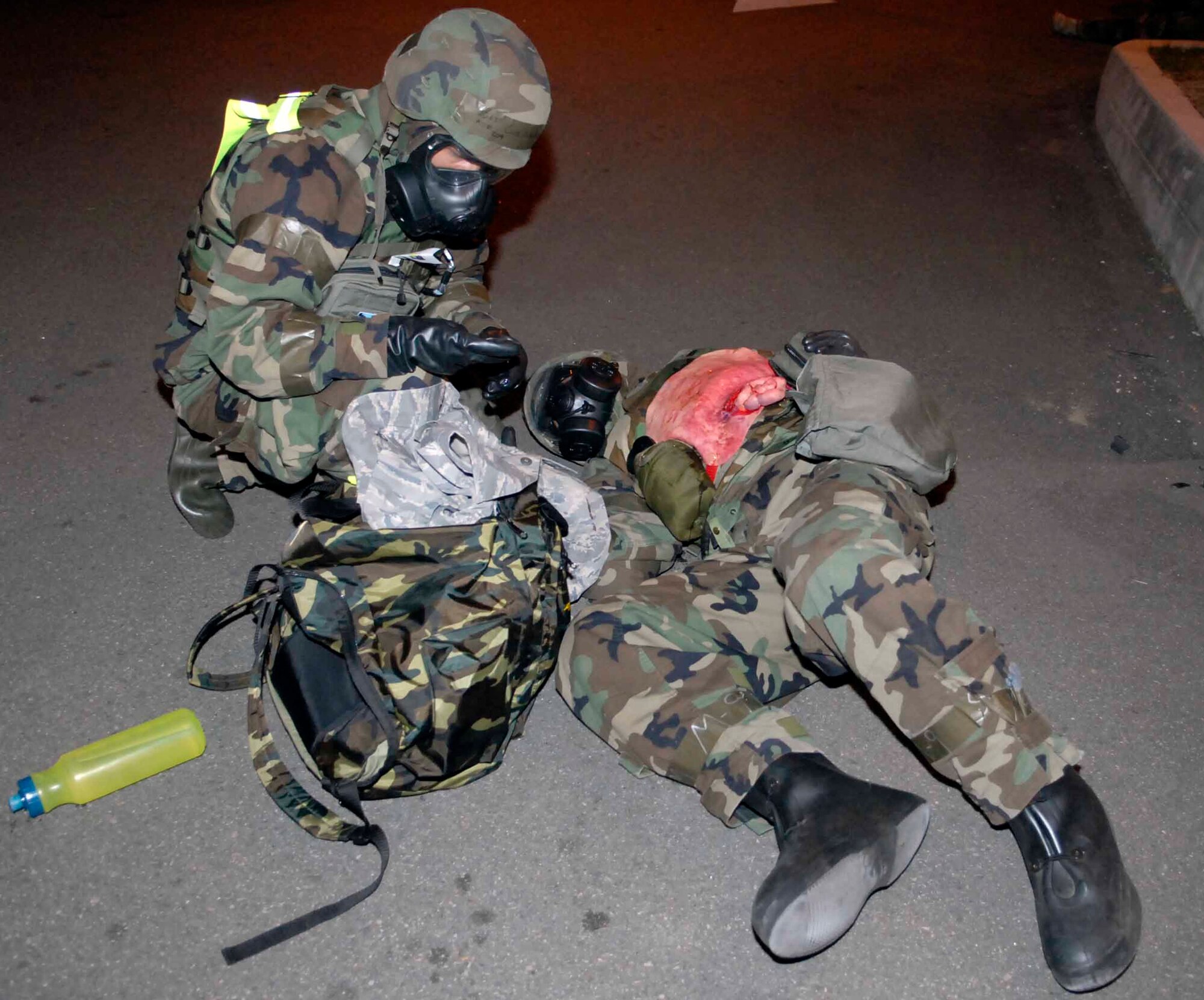OSAN AIR BASE, Republic of Korea -- A member of a post attack reconnaissance team provides self-aid buddy care to a “victim” following a simulated missile attack during Exercise Beverly Bulldog 08-04 Nov. 6. The week-long exercise tests Team Osan’s readiness and ability to execute combat operations, receive follow-on forces and defend the base from attack. (U.S. Air Force photo/Staff Sgt. Scottie McCord)