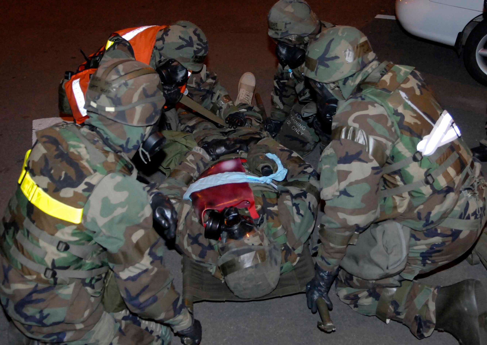 OSAN AIR BASE, Republic of Korea -- Personnel from the 51st Medical Squadron move places an “injured victim” onto a stretcher before transporting him to a medical care facility during Exercise Beverly Bulldog 08-04 Nov. 6. The exercise tests Team Osan’s ability to transition from peacetime to wartime operations, execution of the mission in a war time environment, and response time to major accident and natural disasters. (U.S. Air Force photo/Staff Sgt. Scottie McCord)