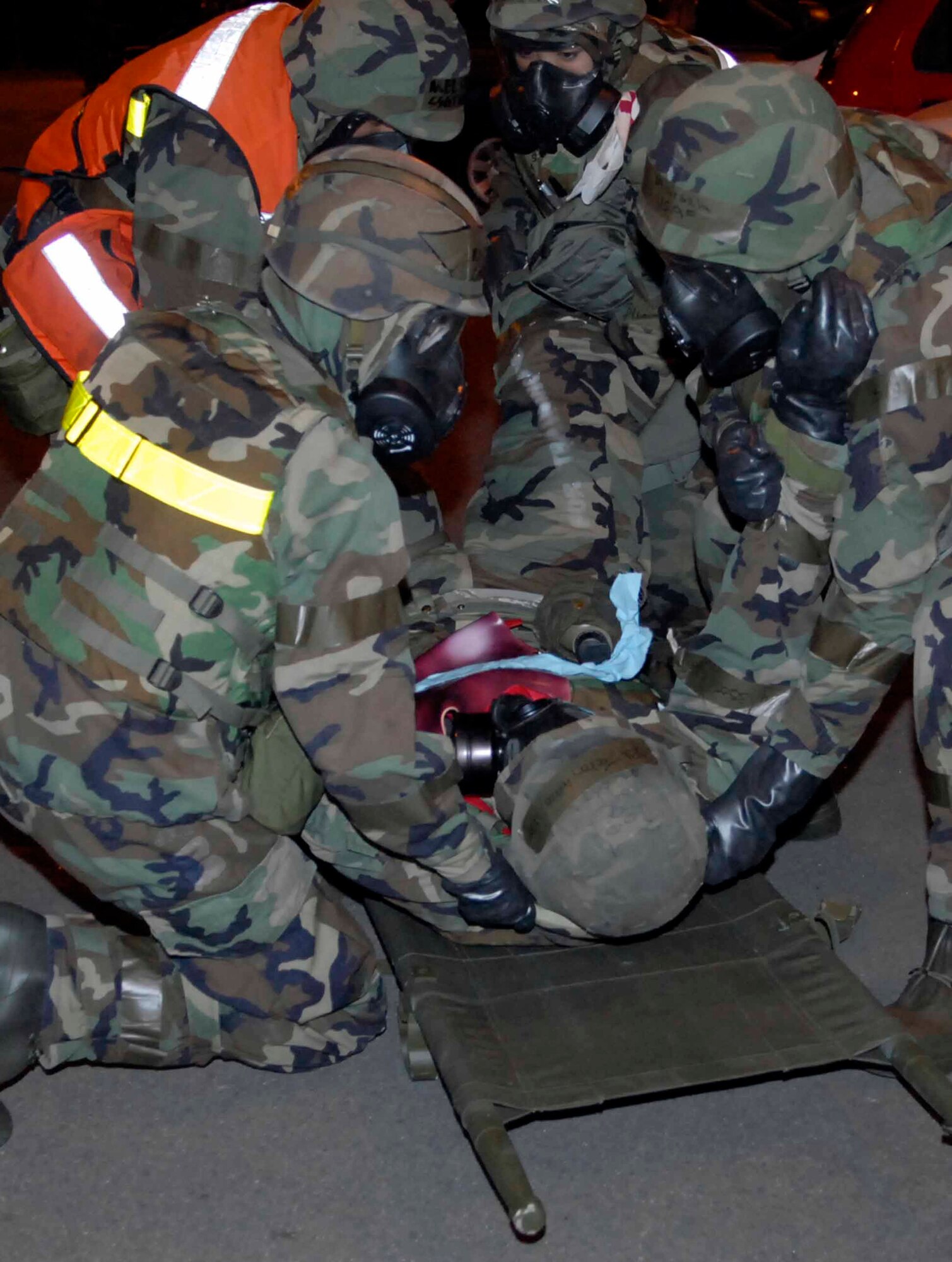 OSAN AIR BASE, Republic of Korea -- Personnel from the 51st Medical Squadron move places an “injured victim” onto a stretcher before transporting him to a medical care facility during Exercise Beverly Bulldog 08-04 Nov. 6. The exercise tests Team Osan’s ability to transition from peacetime to wartime operations, execution of the mission in a war time environment, and response time to major accident and natural disasters. (U.S. Air Force photo/Staff Sgt. Scottie McCord)